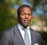 A professional headshot of a man.