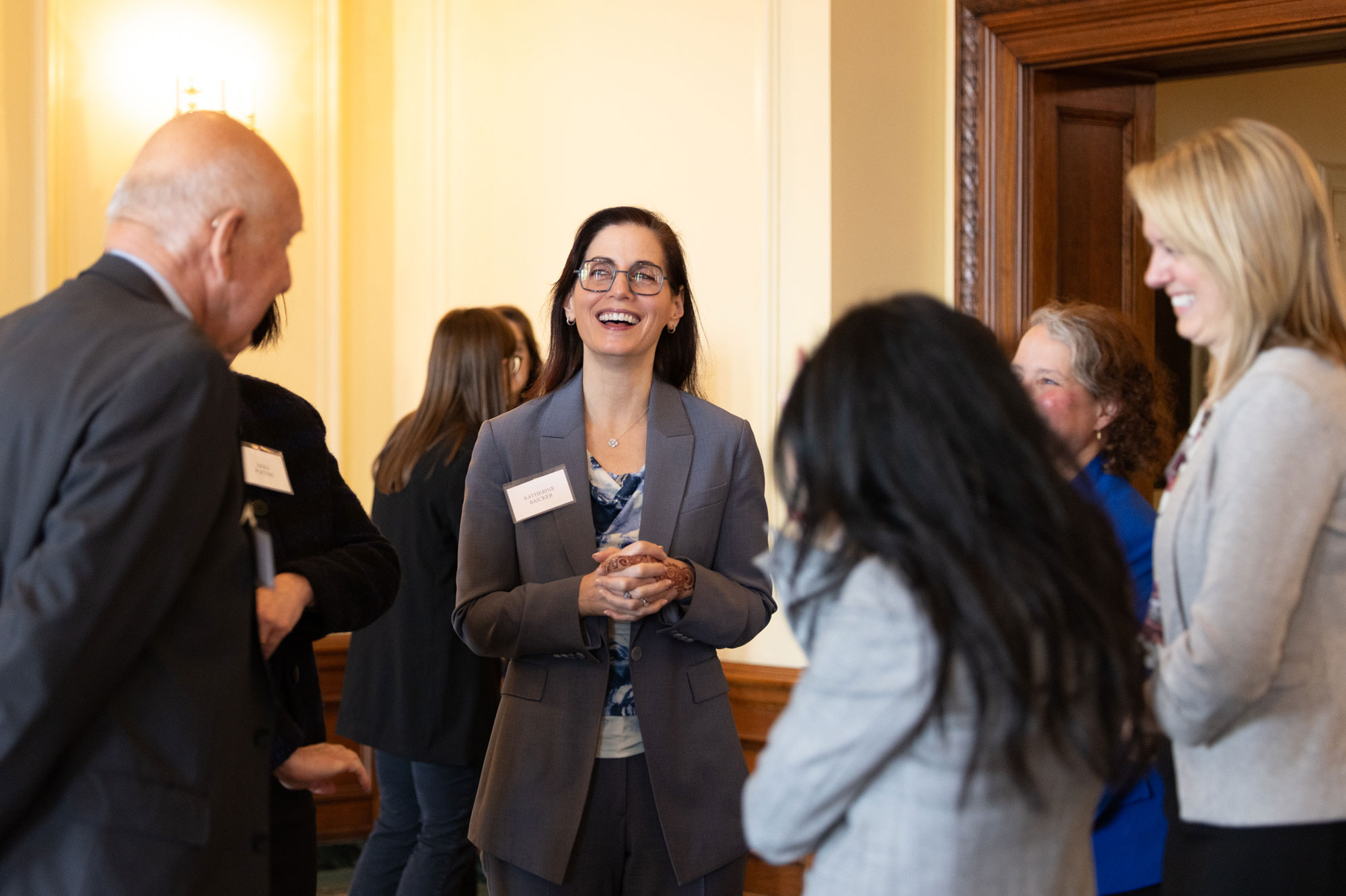 People stand together talking and laughing