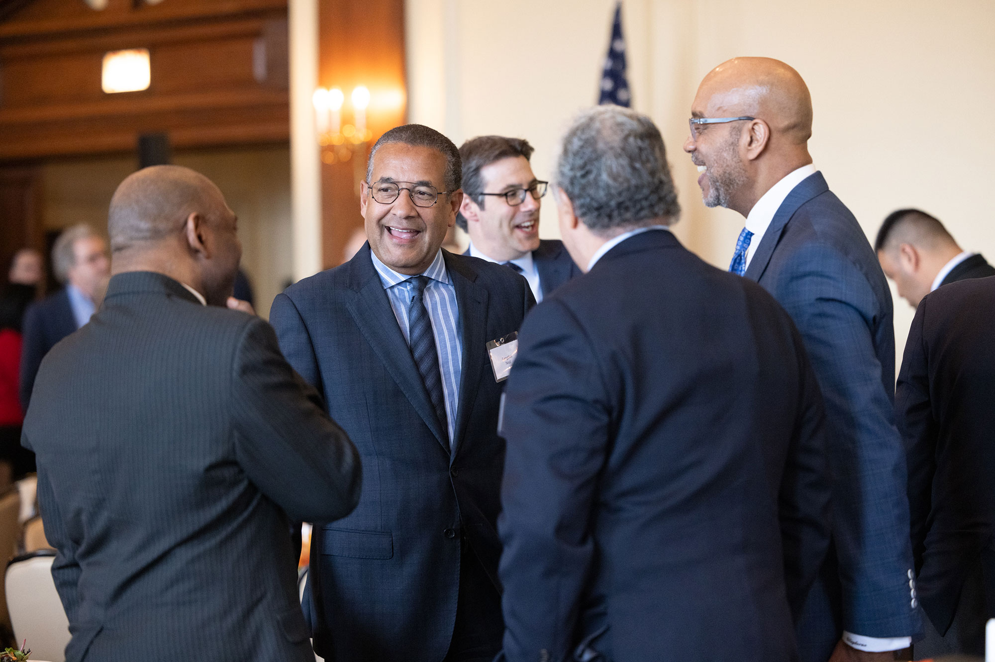 A group of people in suits talking together