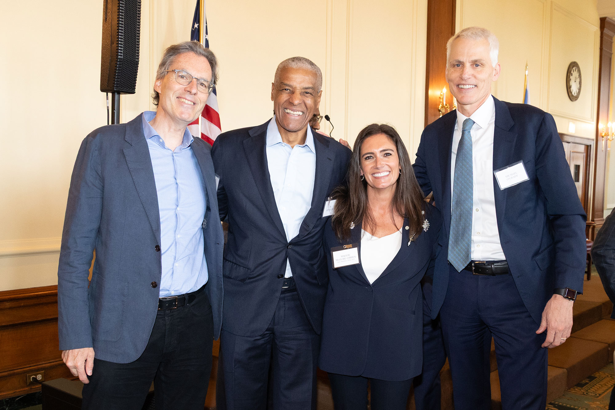 Four people standing and smiling