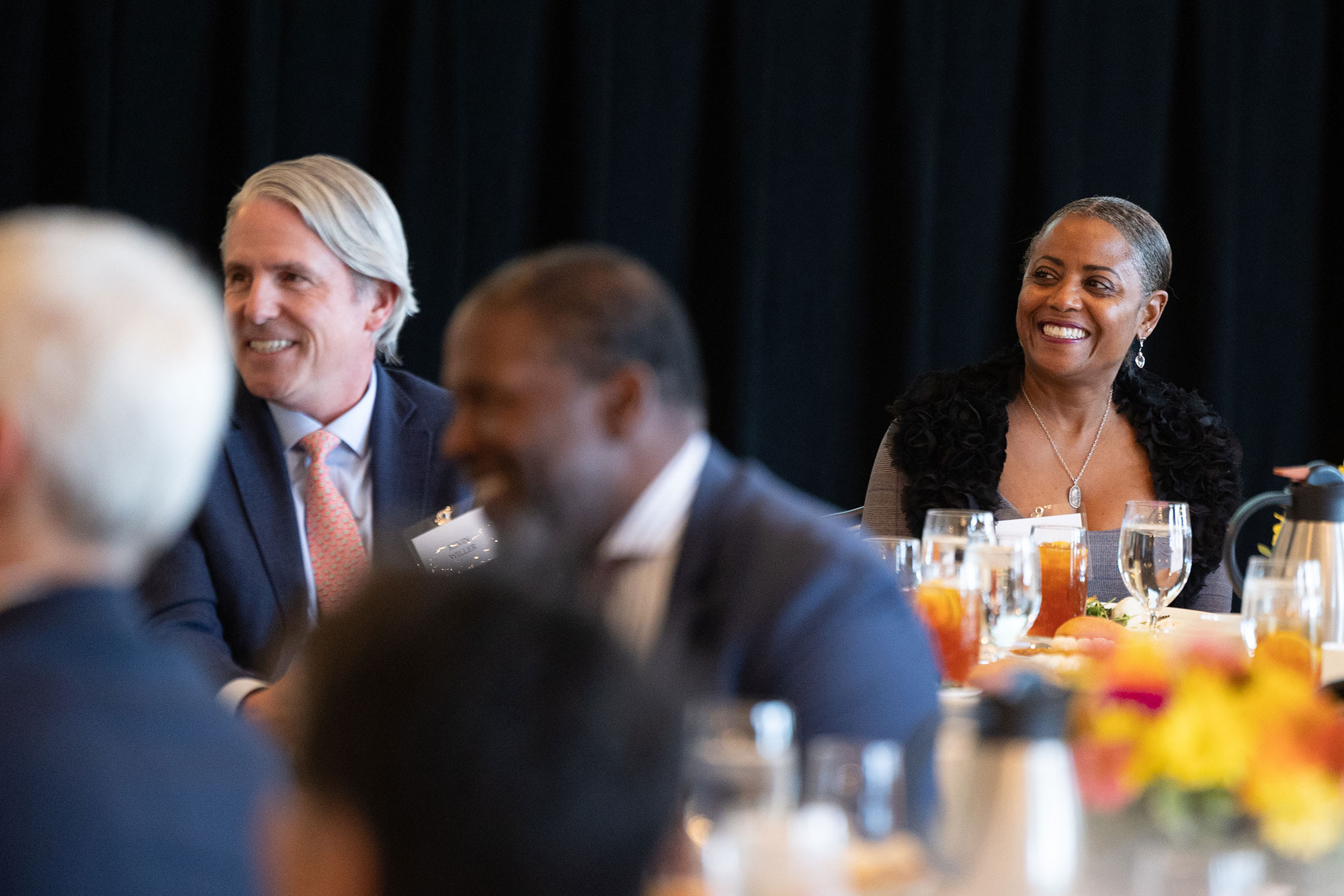 People sitting in the audience smiling