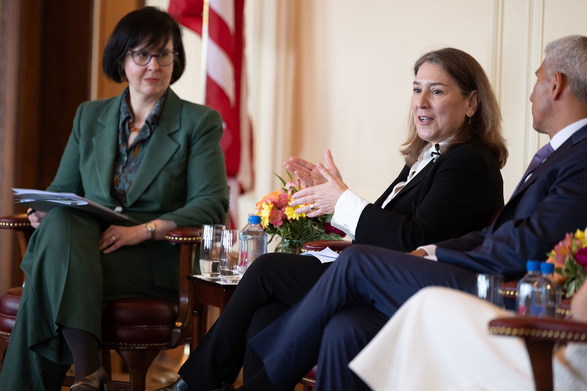 A woman sitting in a chair on stage