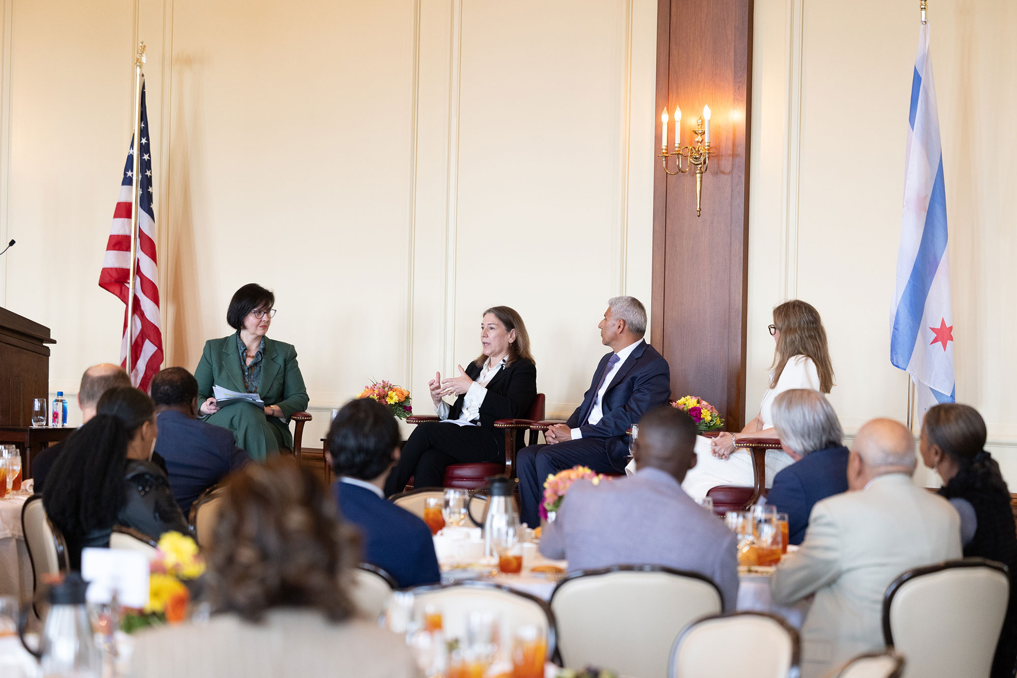 Four people talking on stage with the audience in the foreground