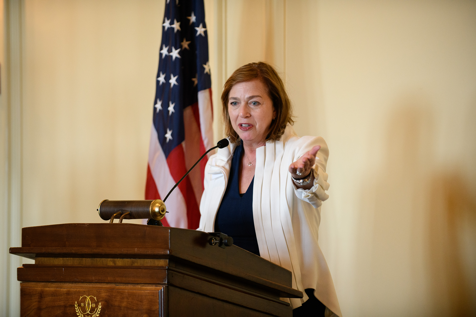 A person speaks while standing at a podium