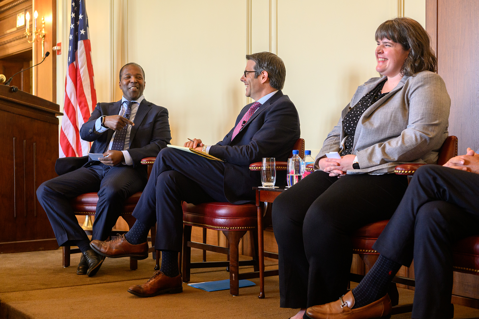 Three people sitting in chairs on stage