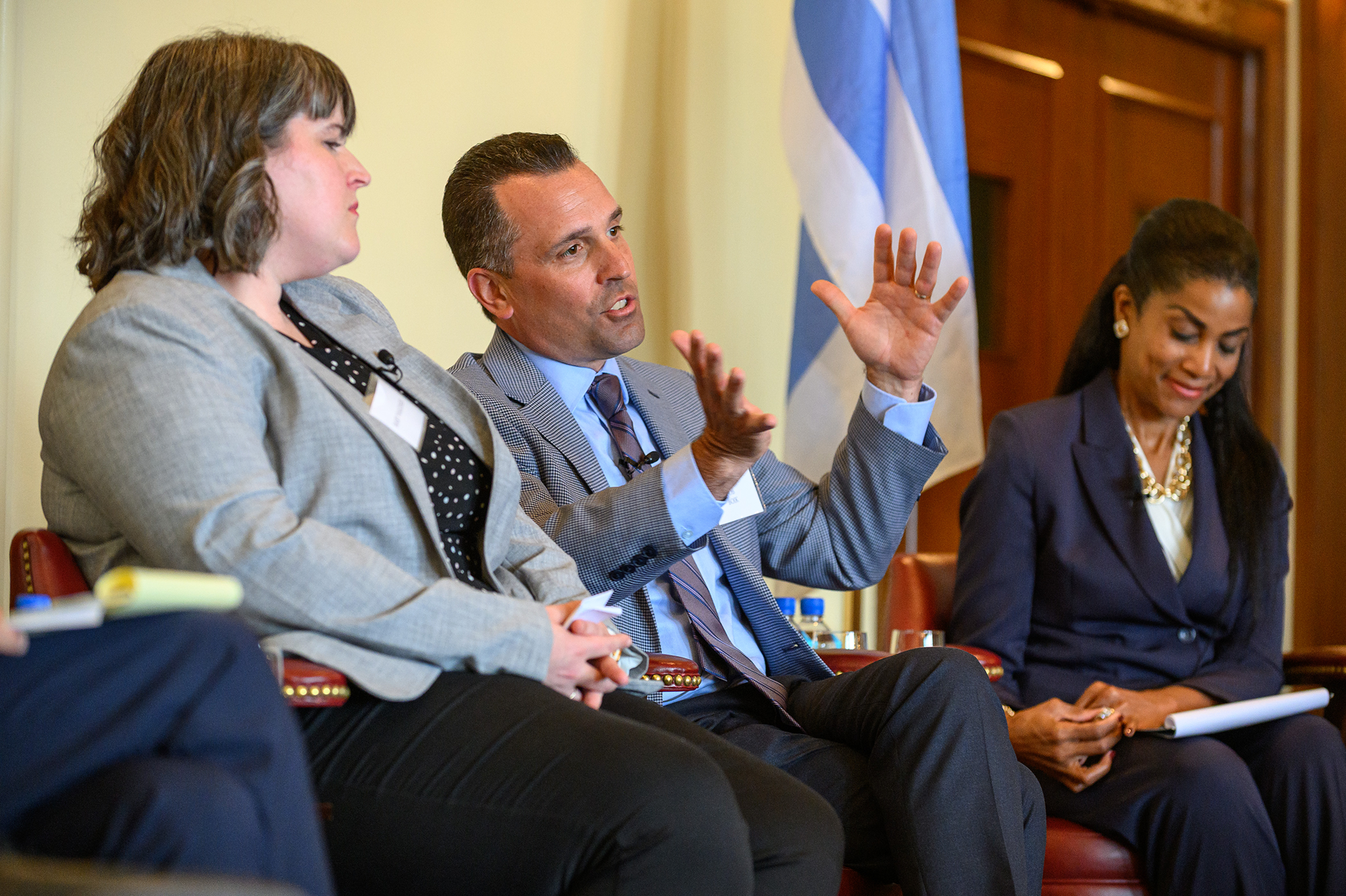 A person talks while sitting on stage