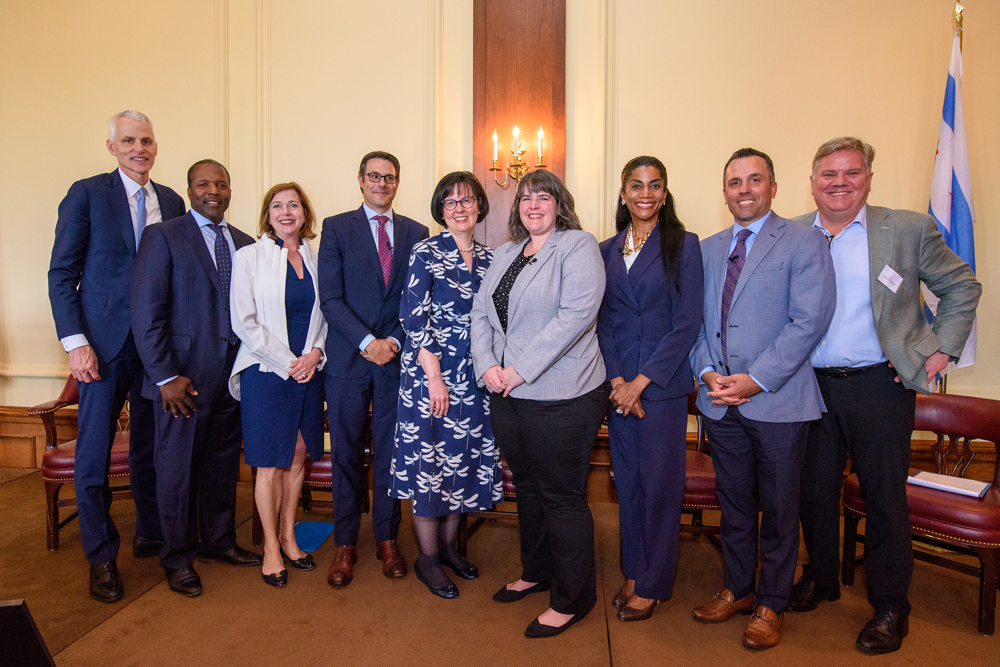 A group of people stand on stage facing the camera