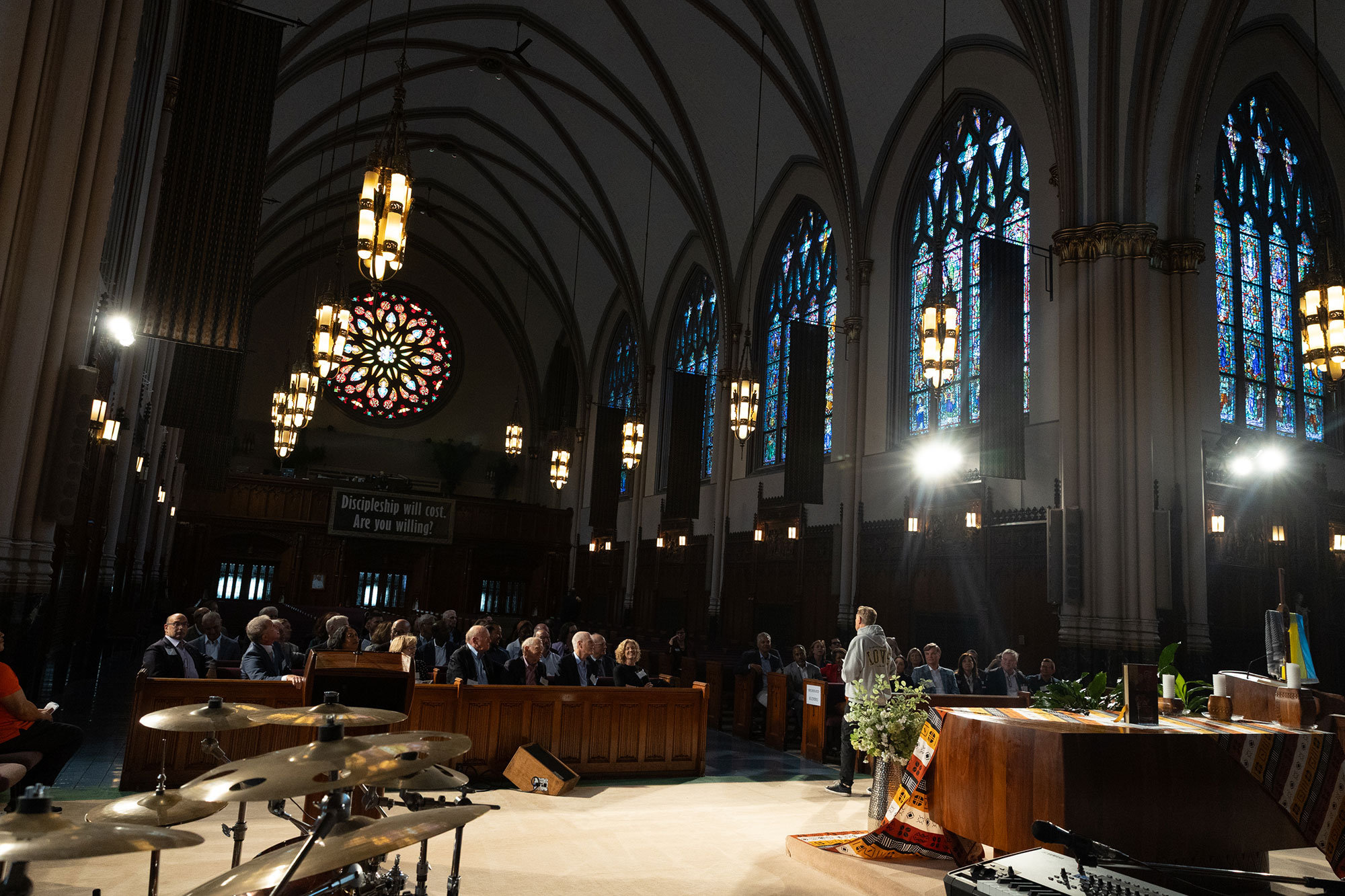 People sit in pews inside a church