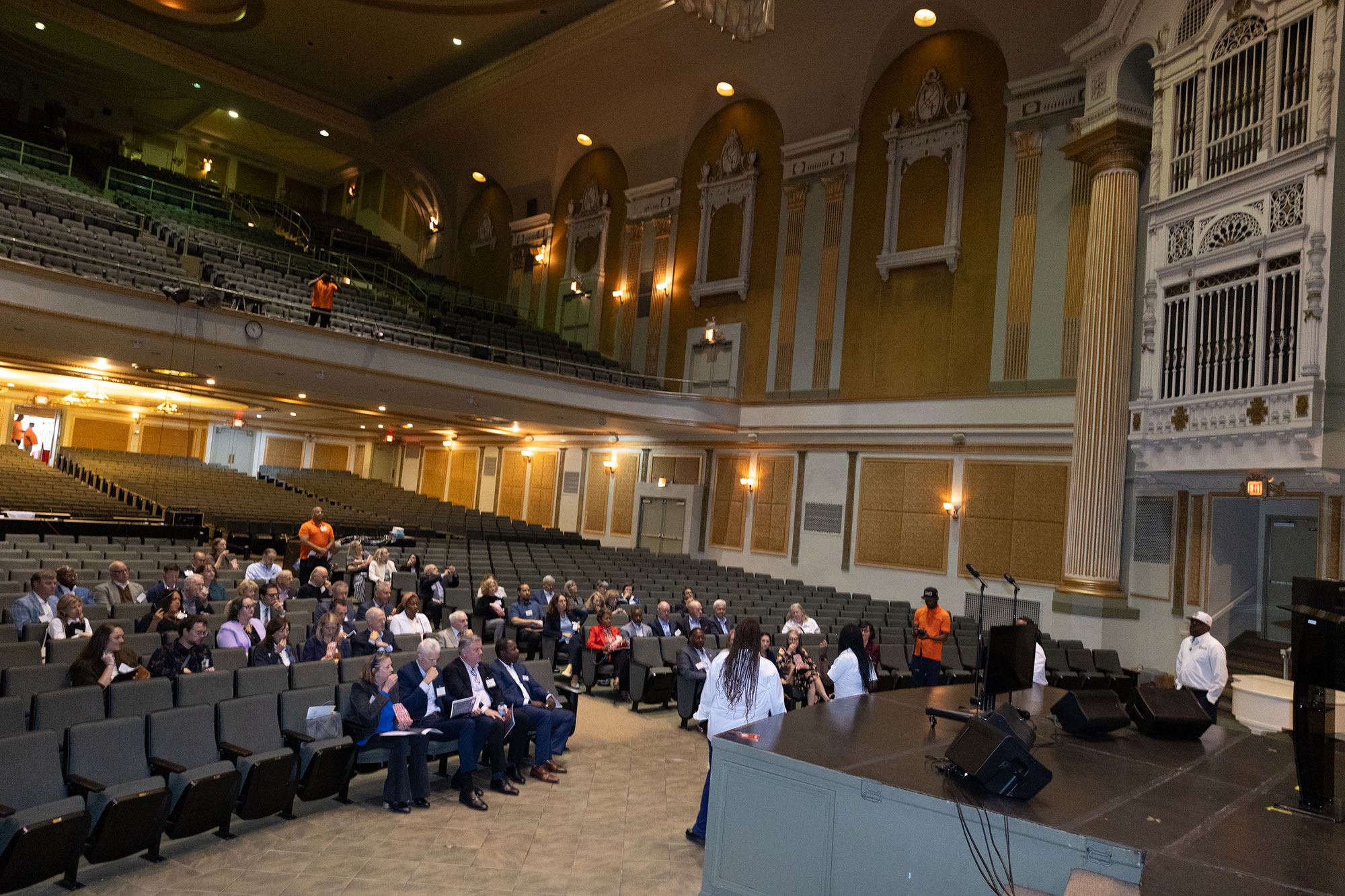 A large group of people seated inside a theater