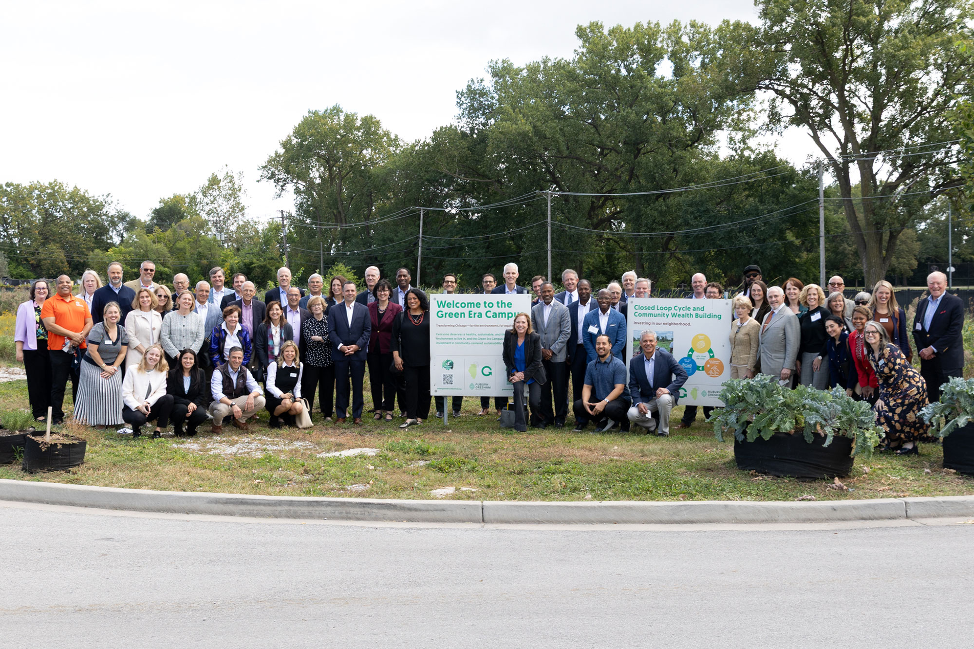 A big group of people in front of outdoor signs