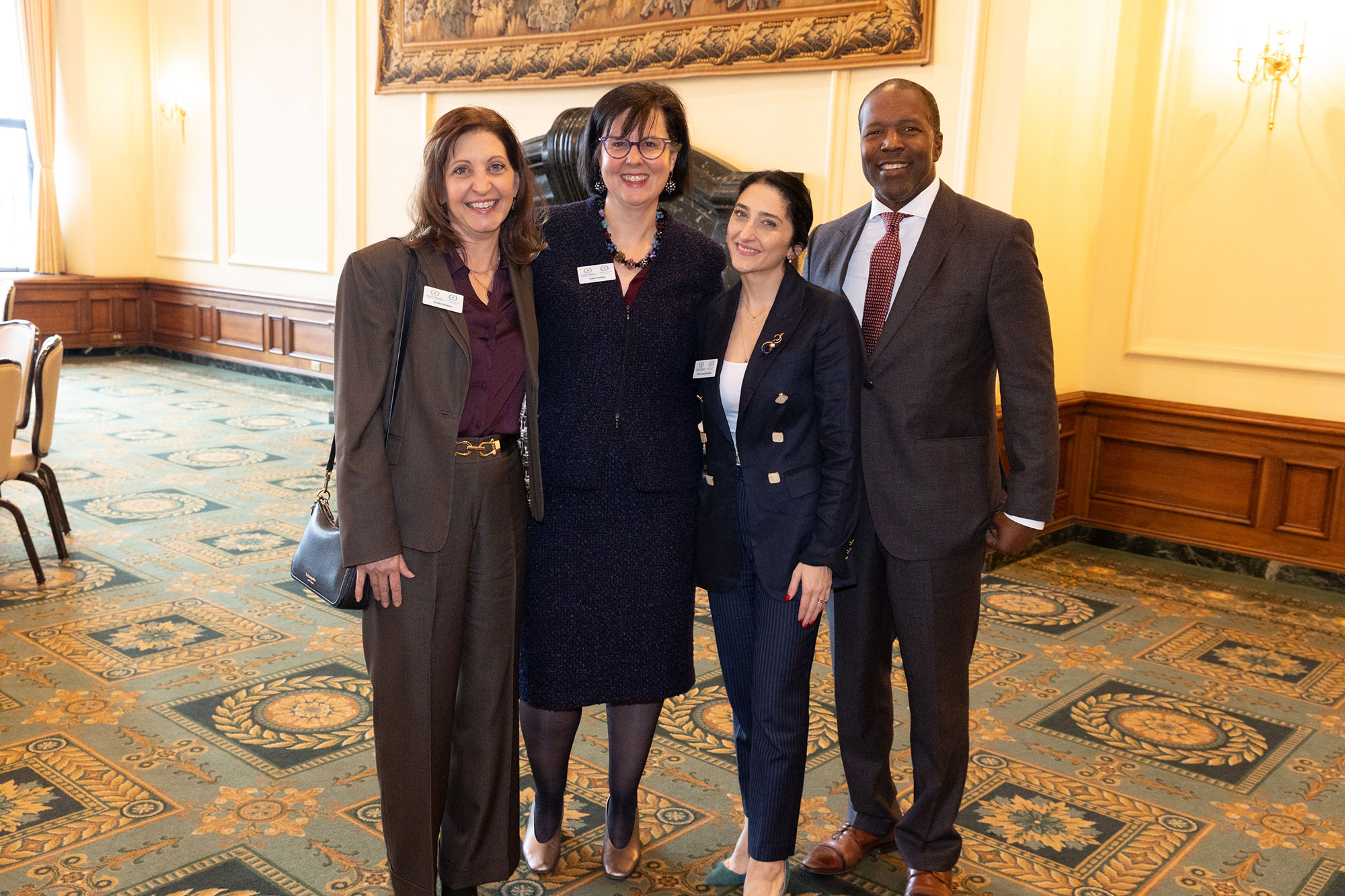 Four people stand together in a room
