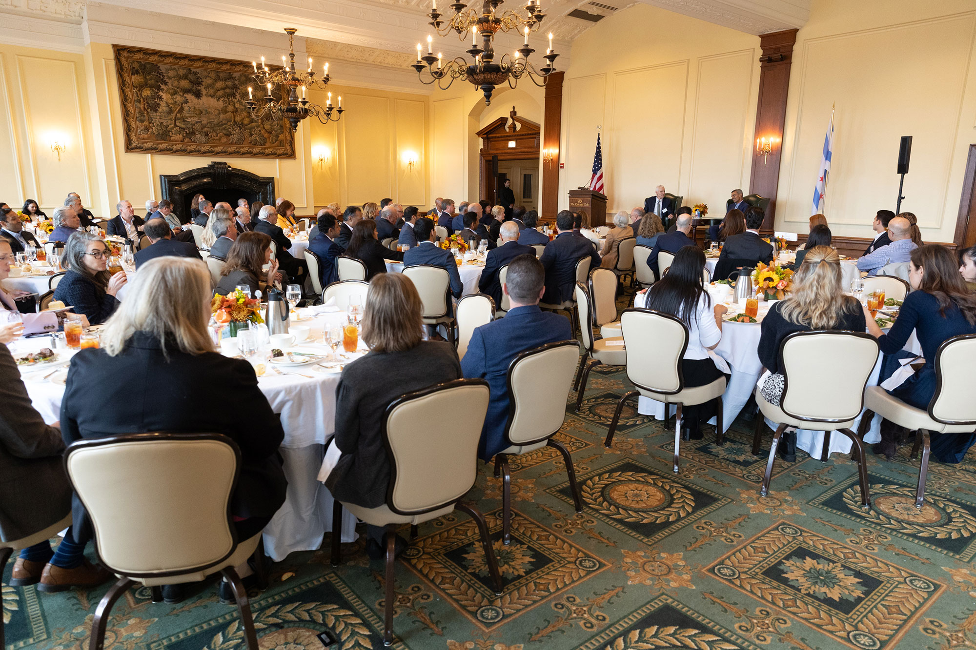 A room full of people sitting at dining tables