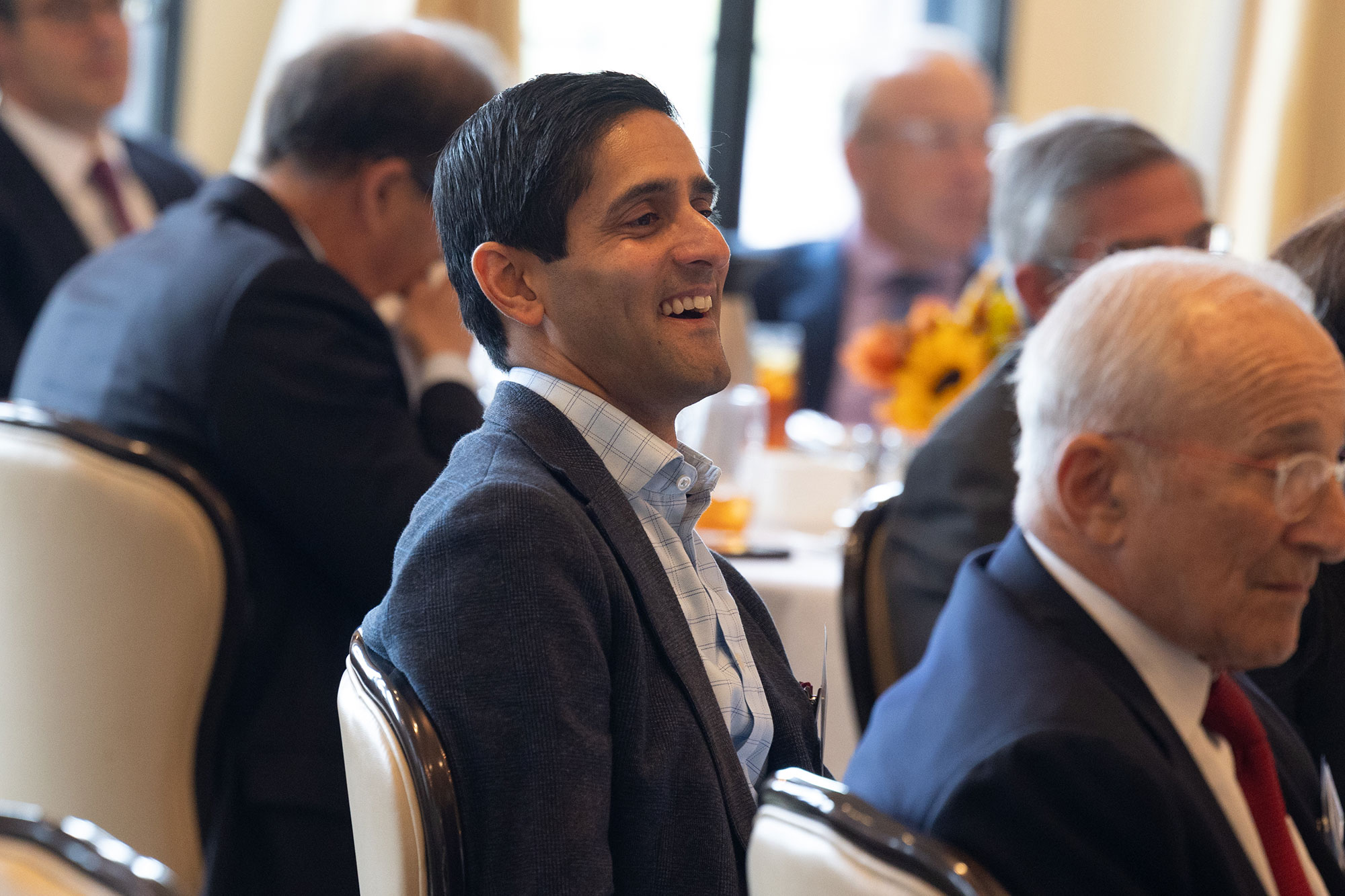 A person laughs in the audience