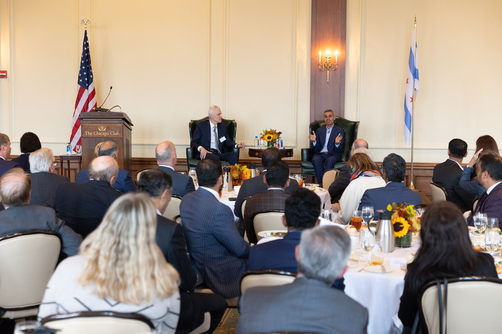 Two people on stage, with the audience in the foreground