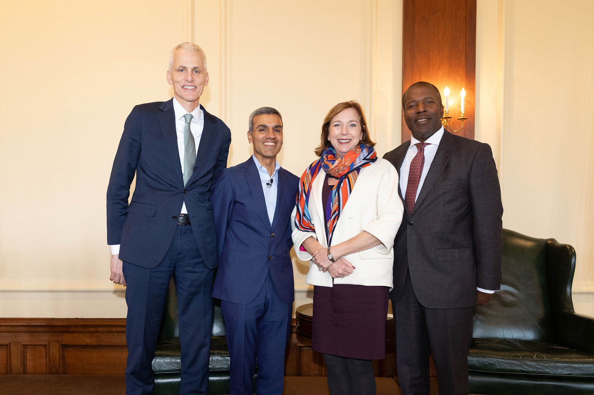 Four people stand together