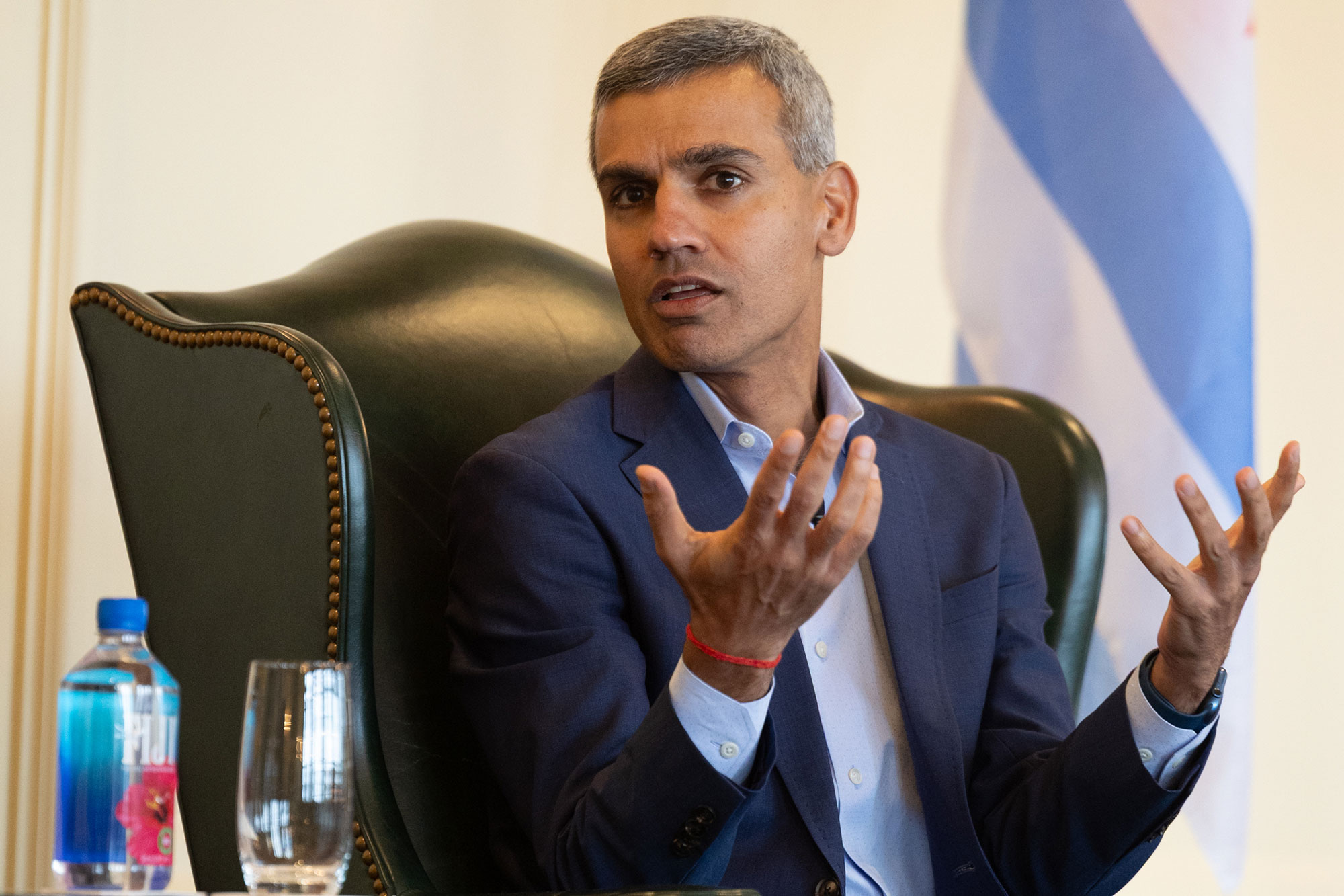 A person speaks while sitting in a chair