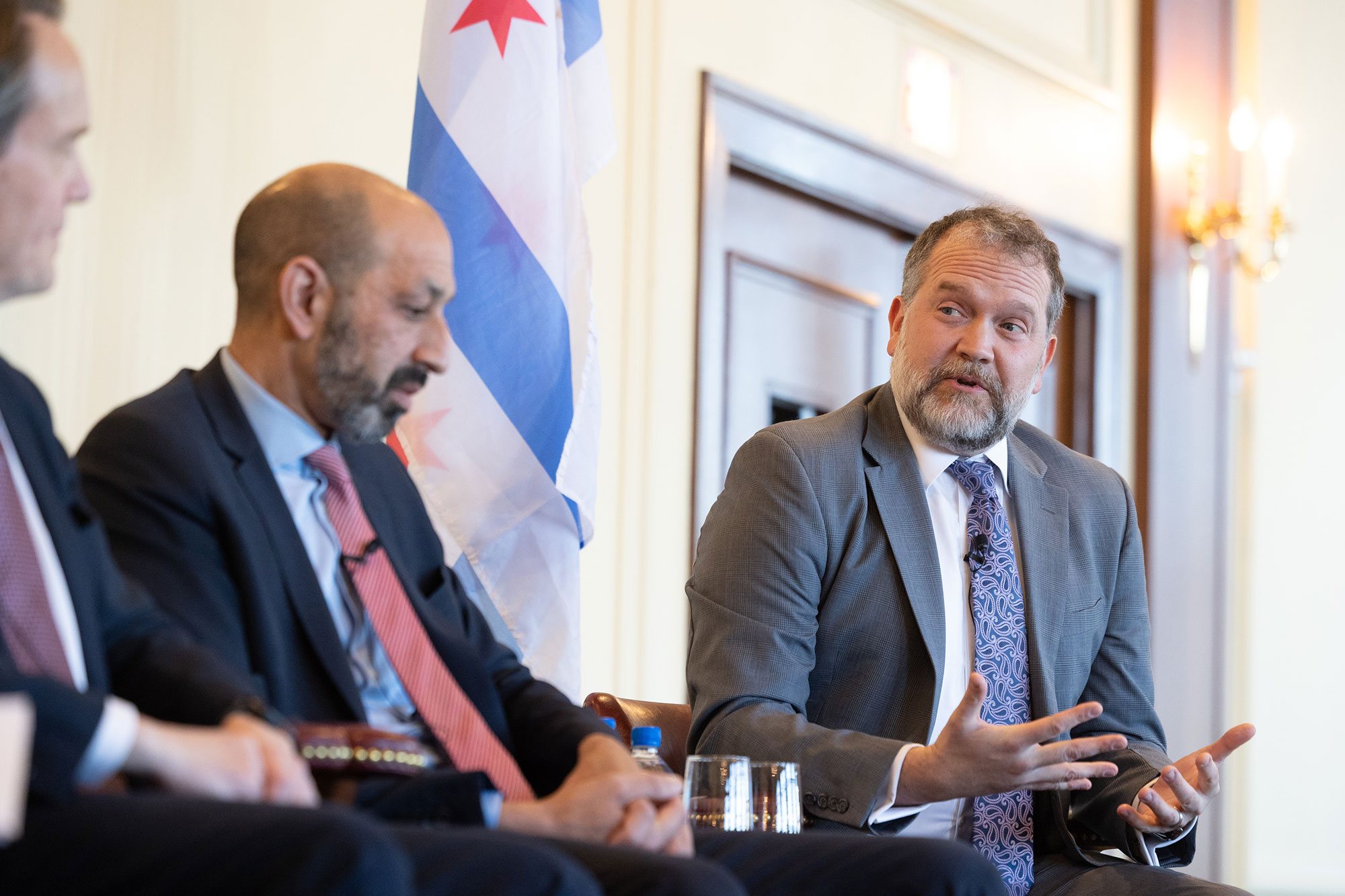 A person sits on stage while talking