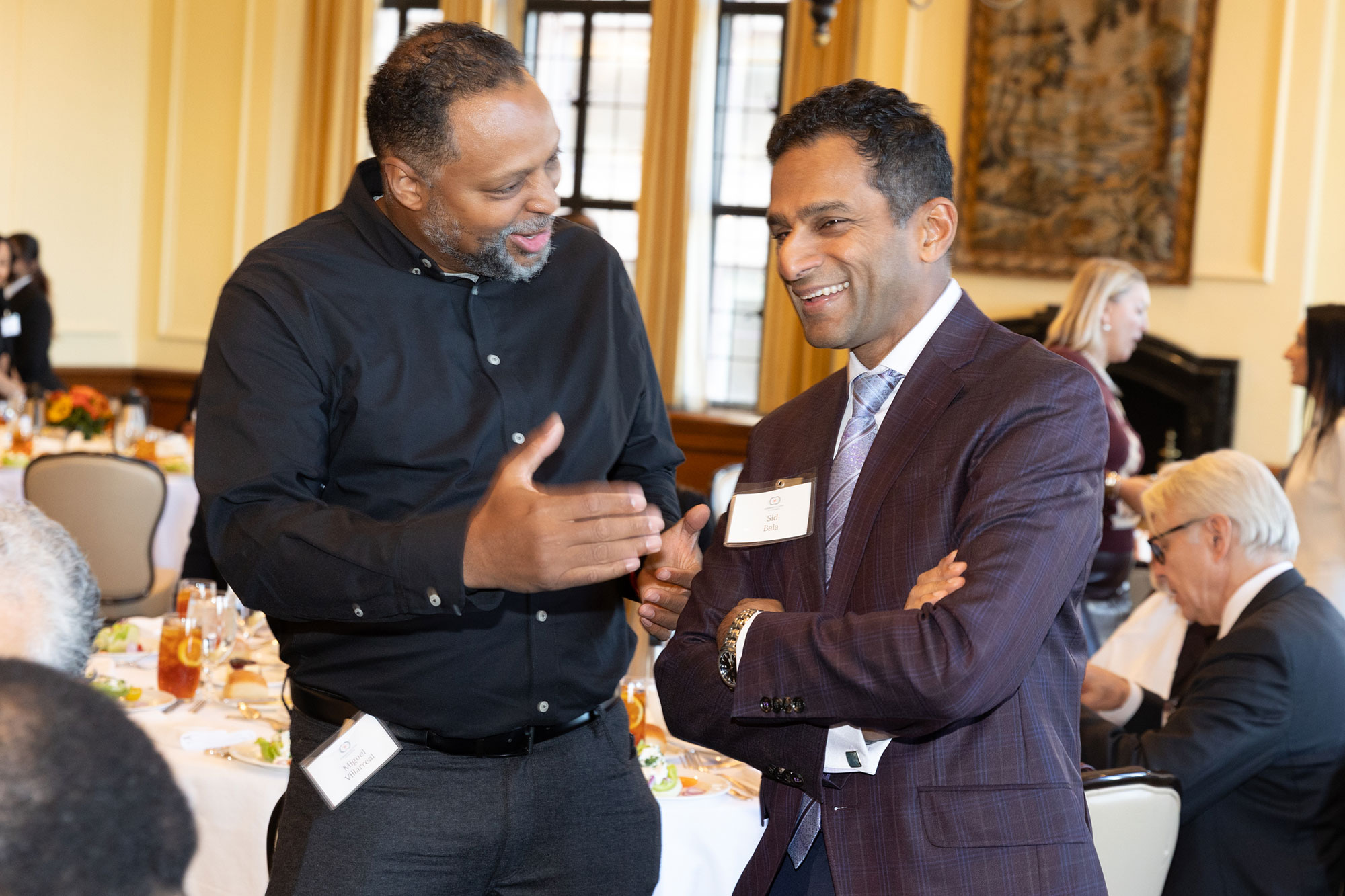 Two people stand talking together