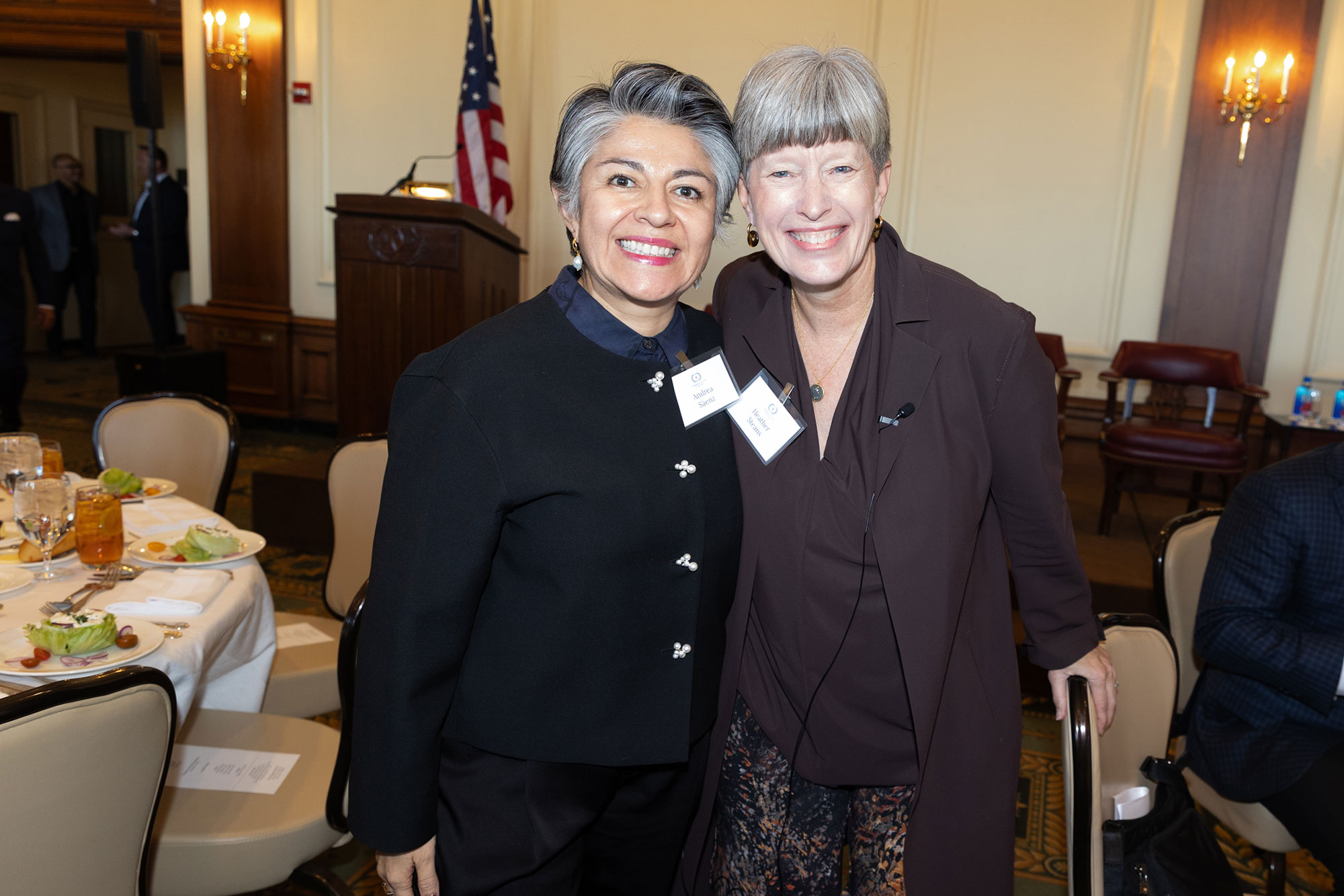 Two people stand and pose together