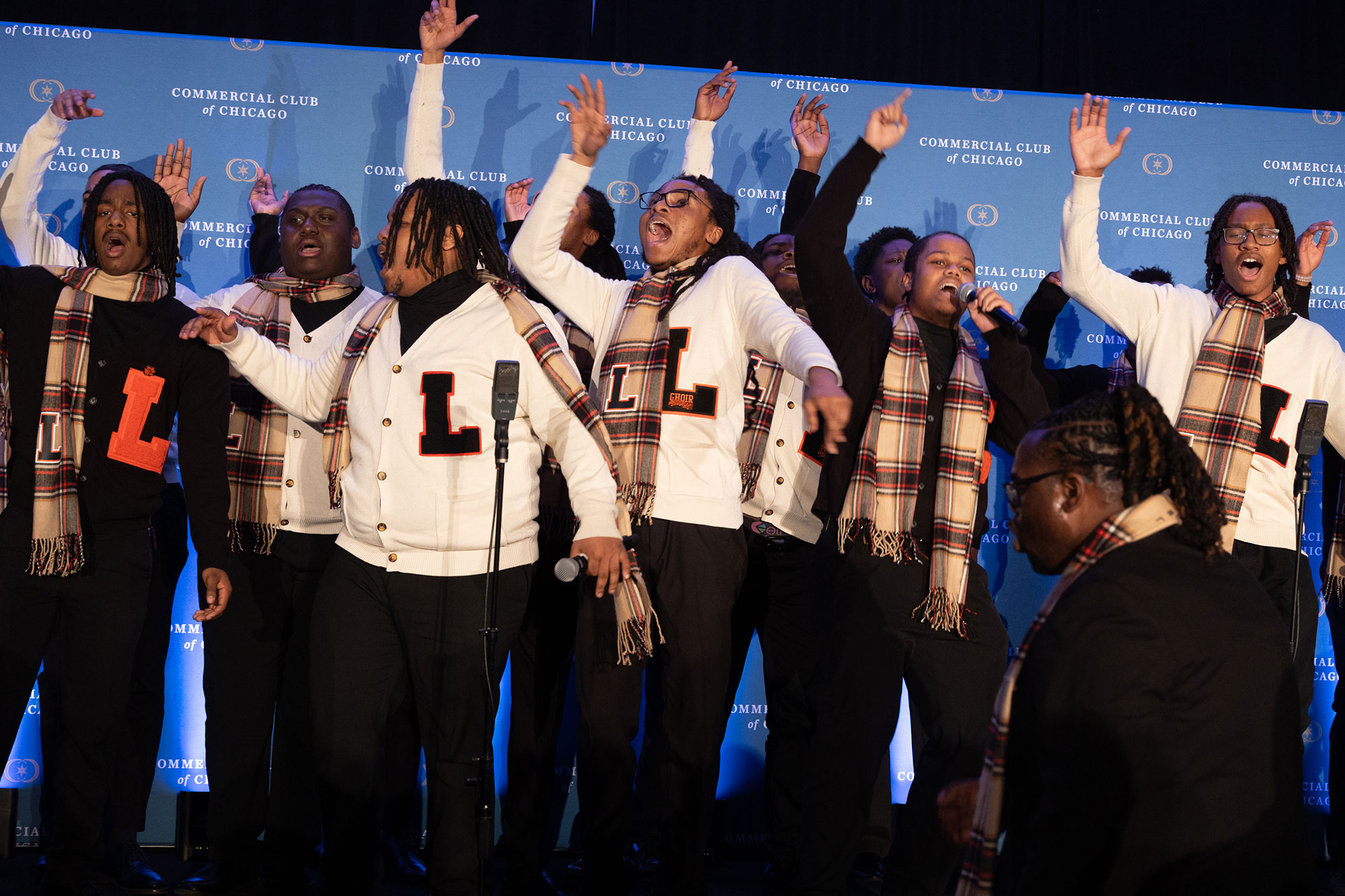 A group of people sing on stage