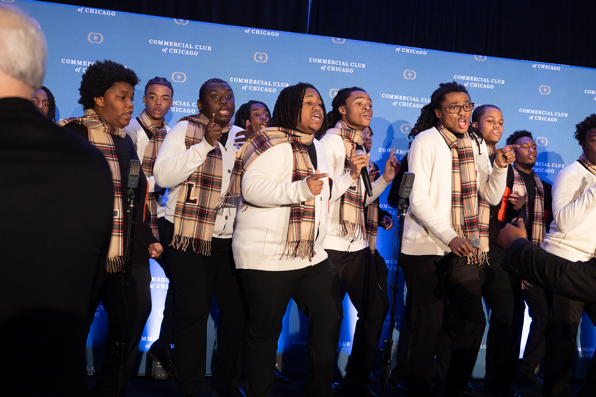 A group of people sing on stage
