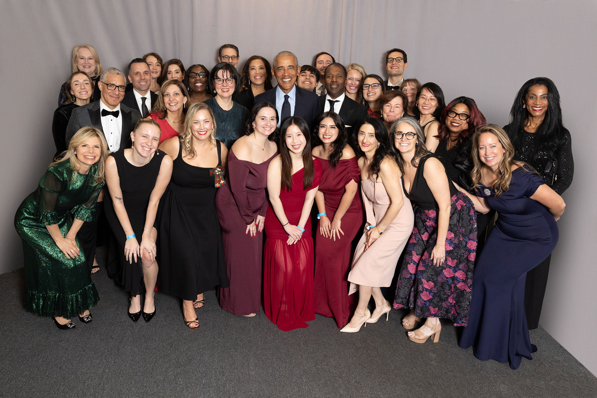 A large group of people stand and pose together