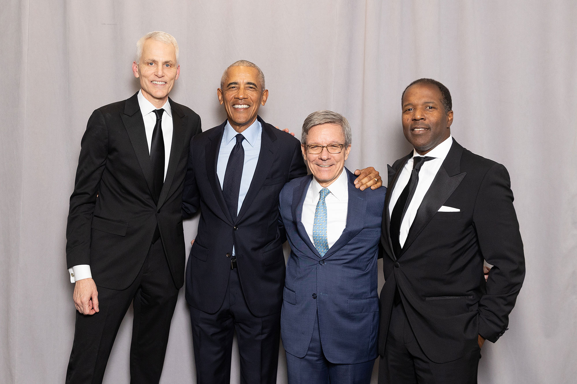 Four people pose together while standing