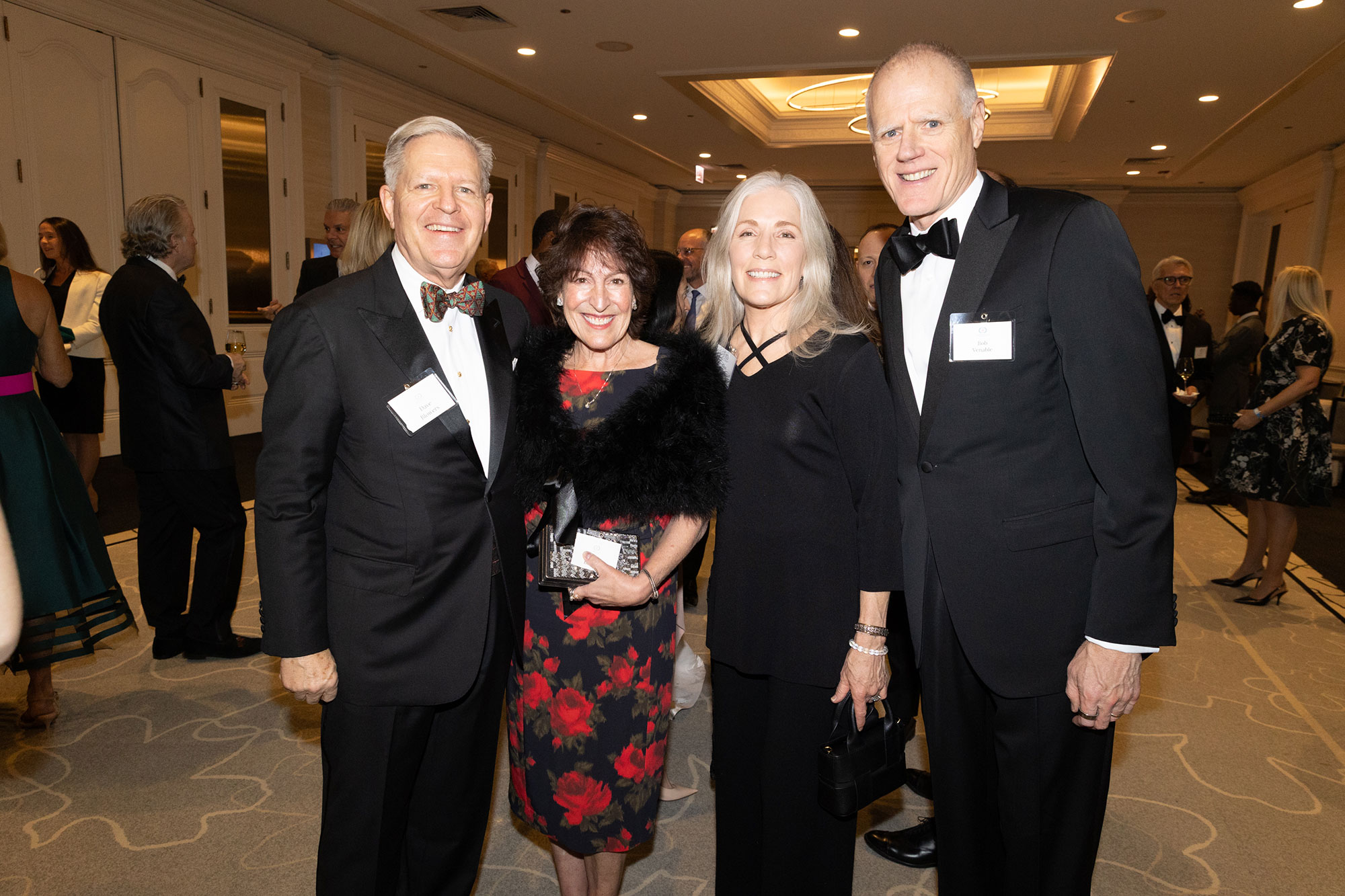 Four people stand together