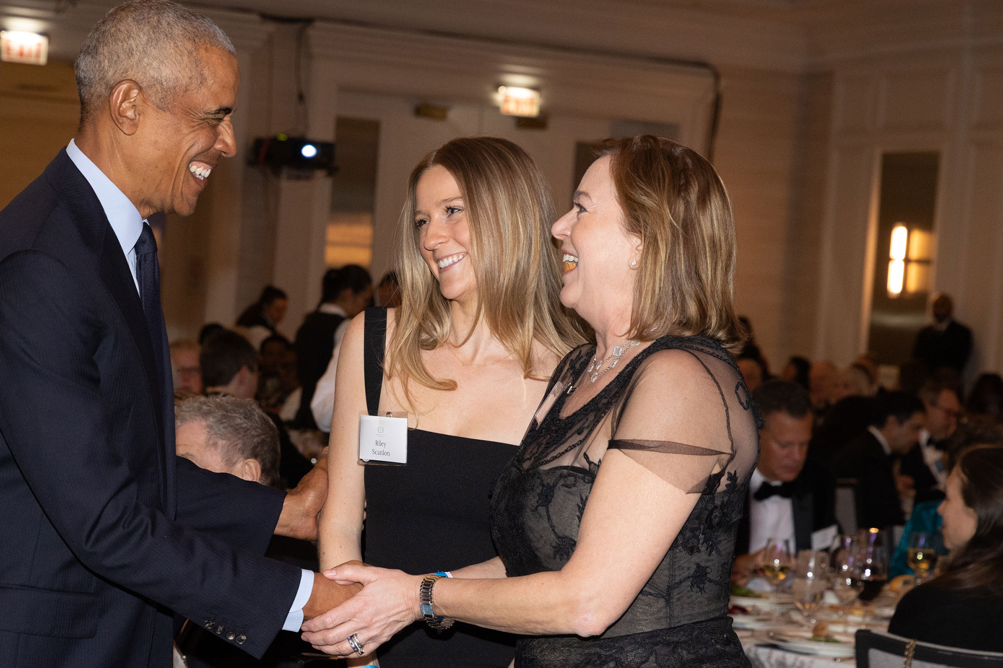 A person shakes hands with President Obama