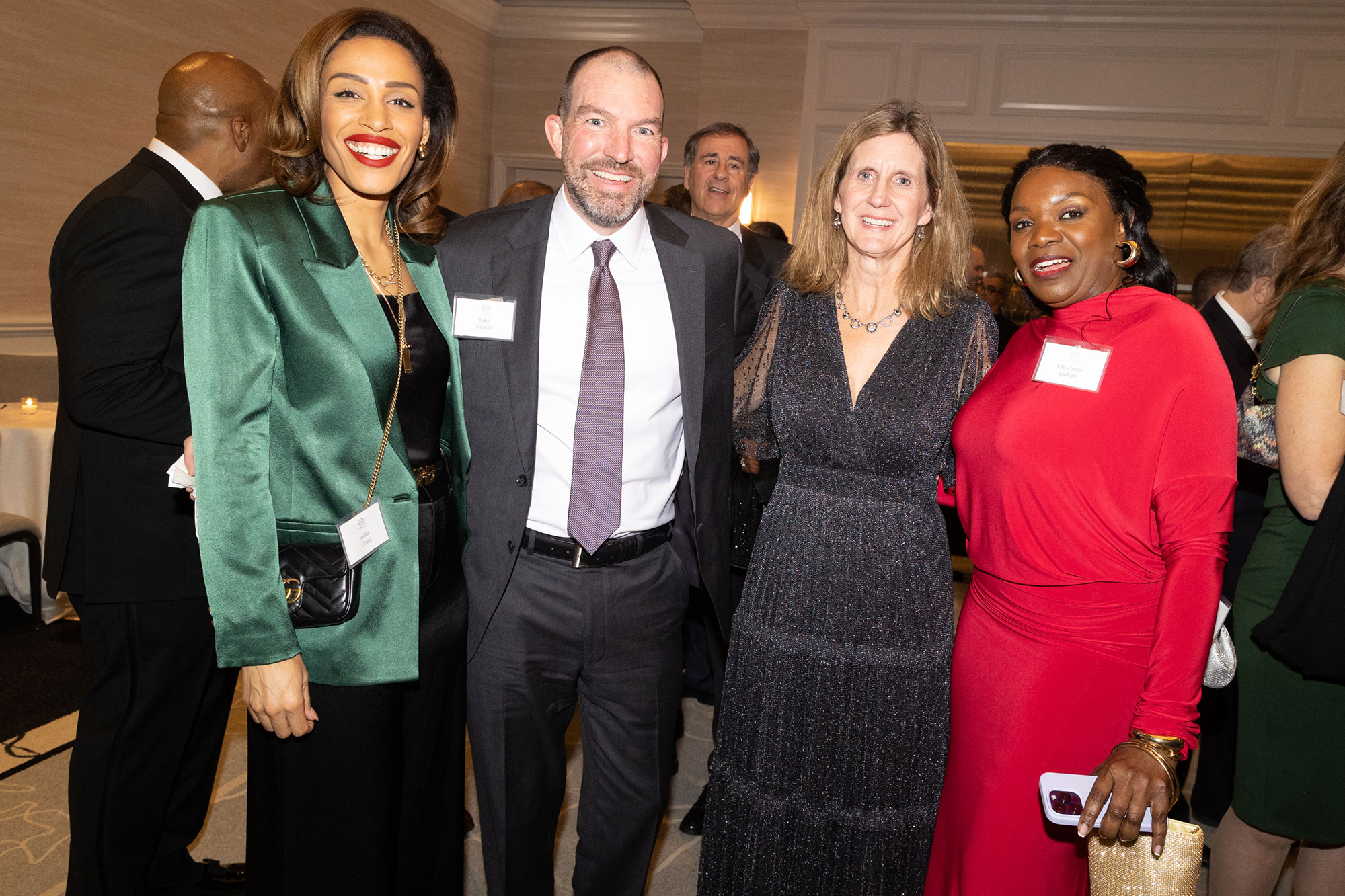 Four people stand together