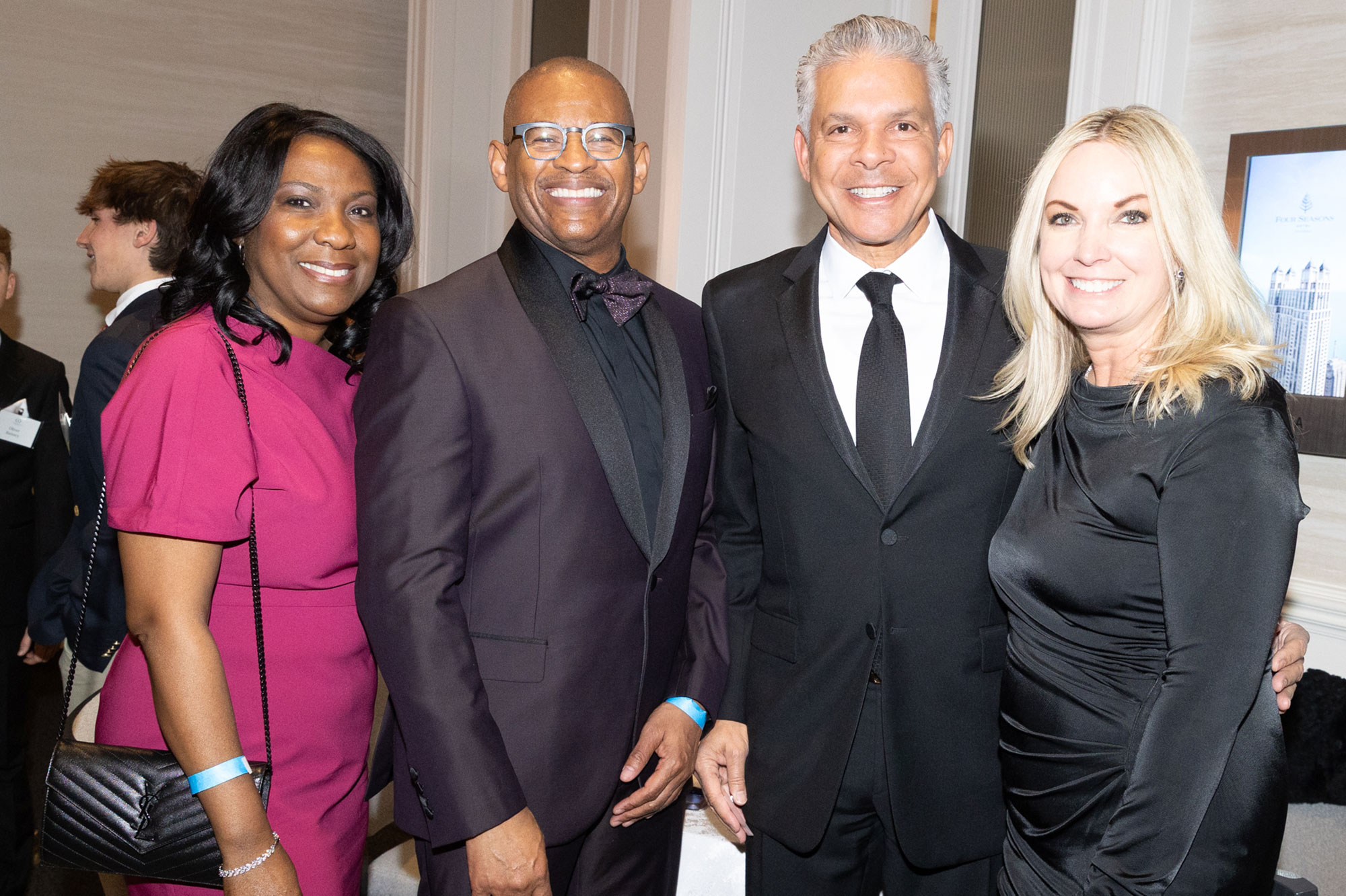 Four people stand together