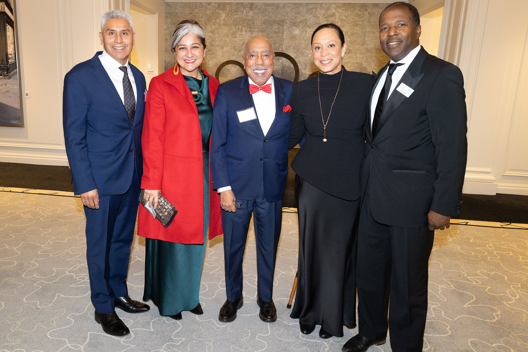 Five people stand together