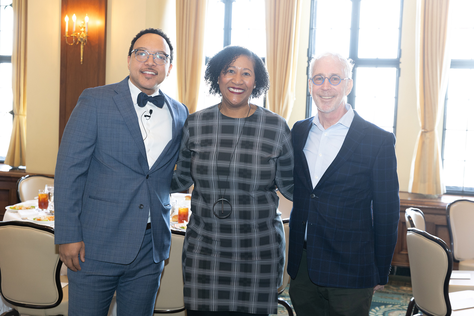 Three people stand together