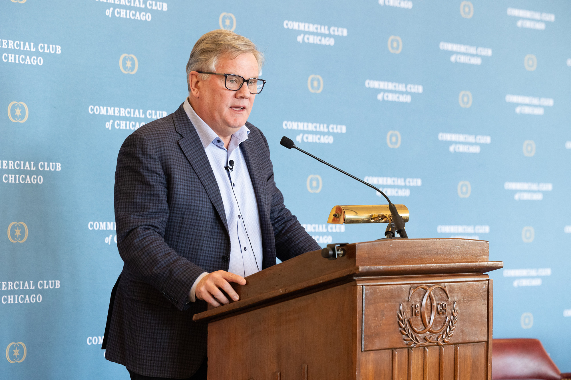 A person stands behind a podium