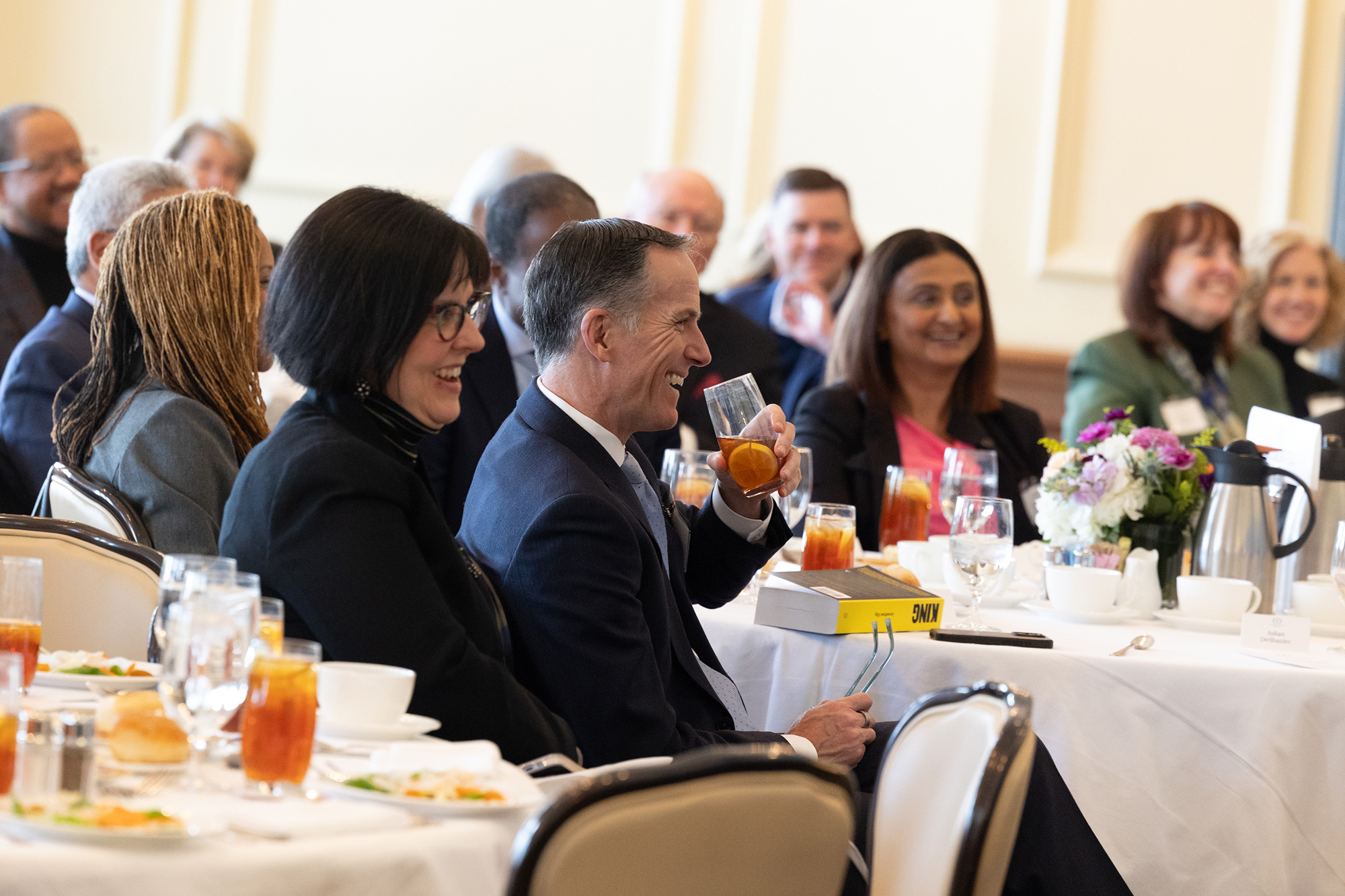 People sitting at tables in an audience