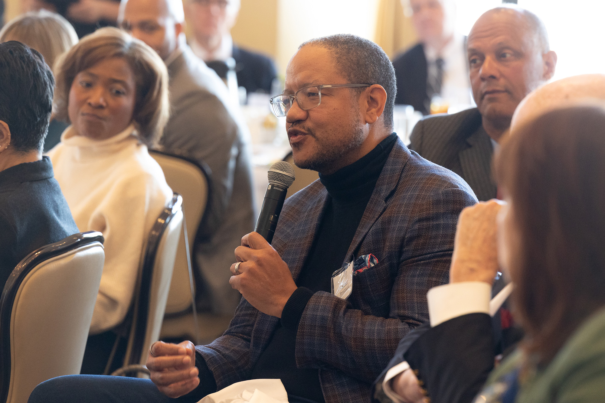 A person speaks into a microphone