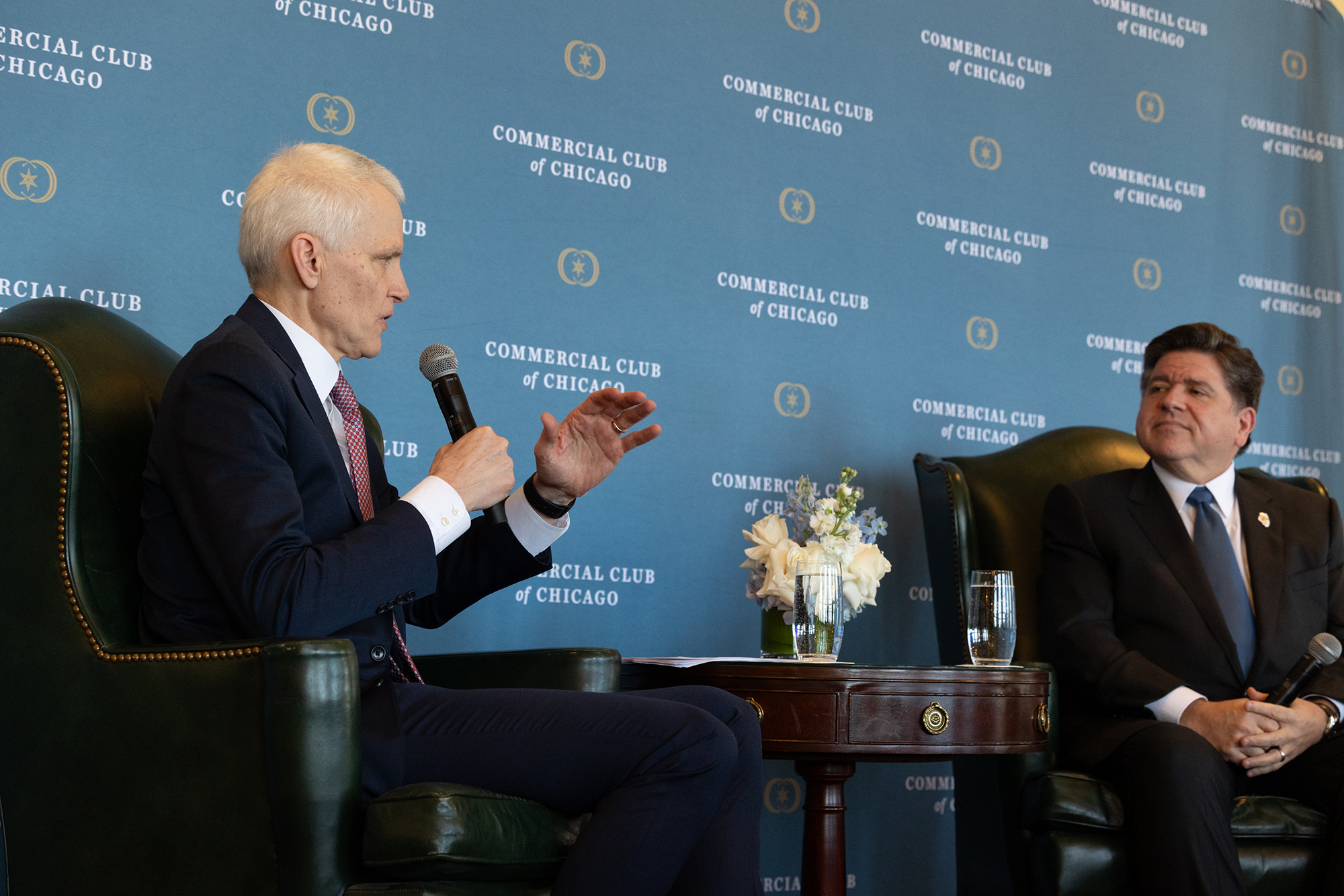 Two people speak together on stage