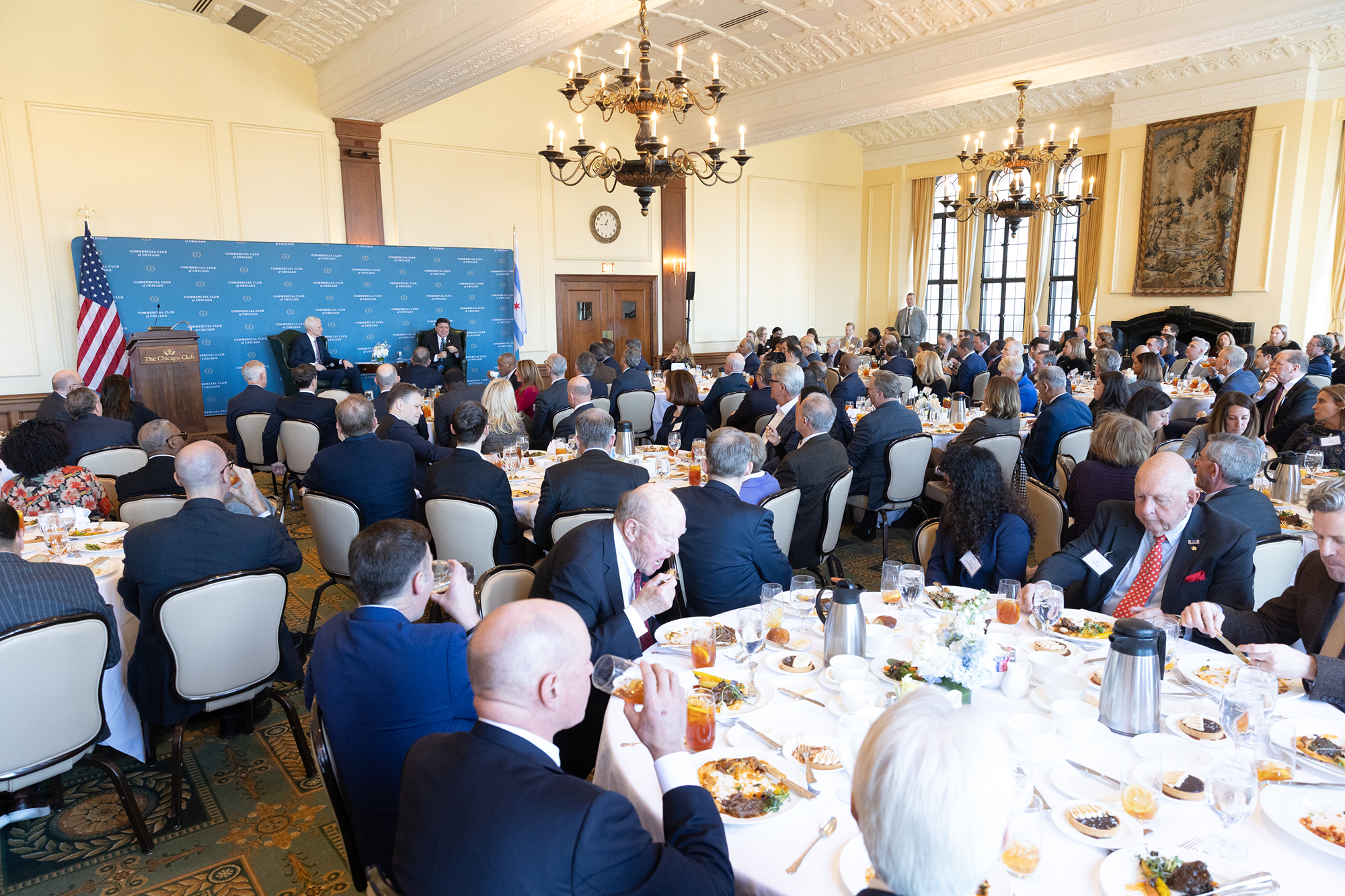 A room of people sitting at tables