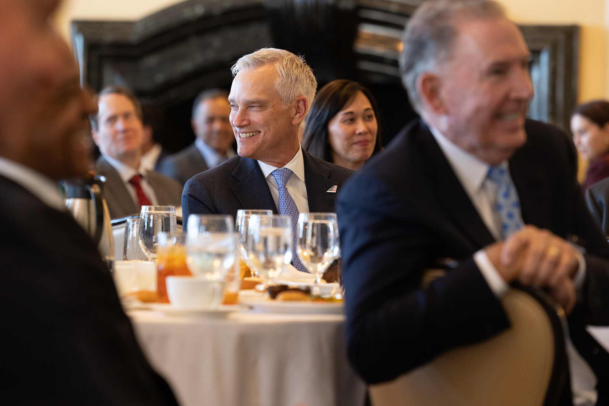 People sitting at tables in an audience