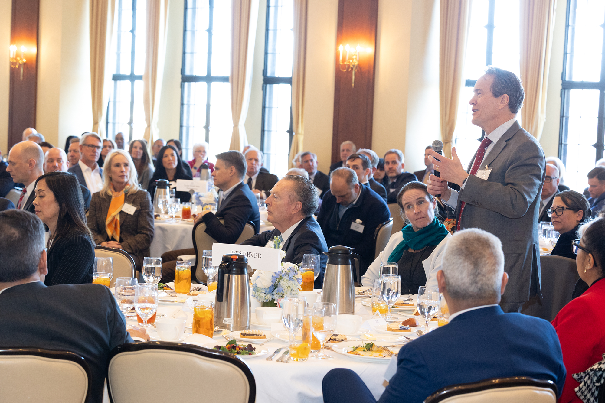 A person in the audience speaks into a microphone