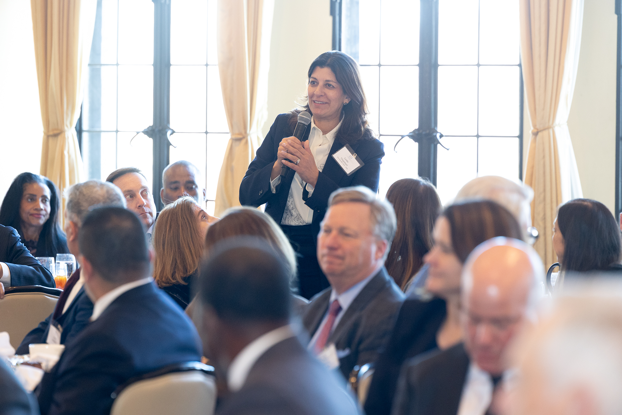 A person in the audience speaks into a microphone
