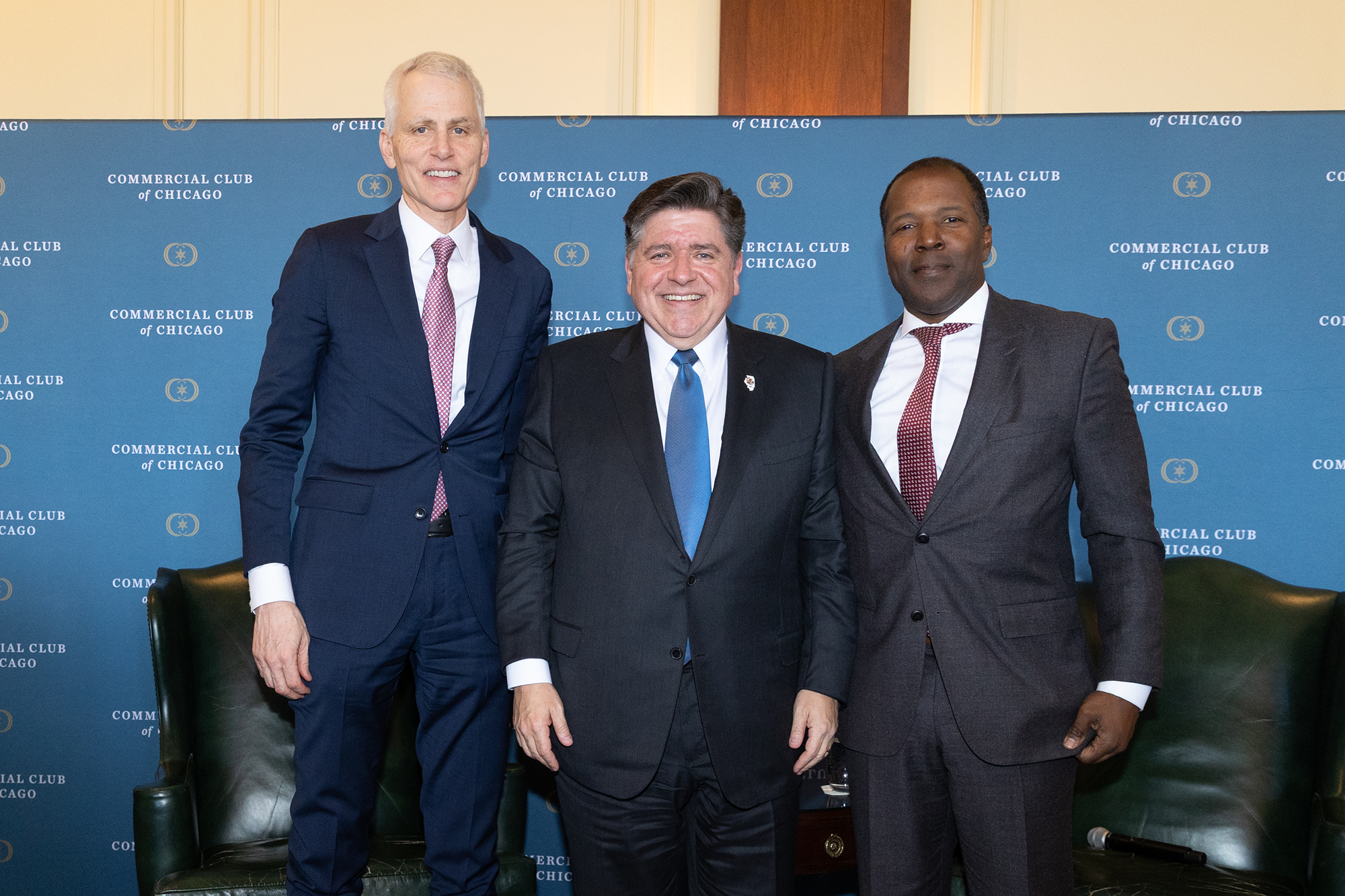 Three people stand together on stage
