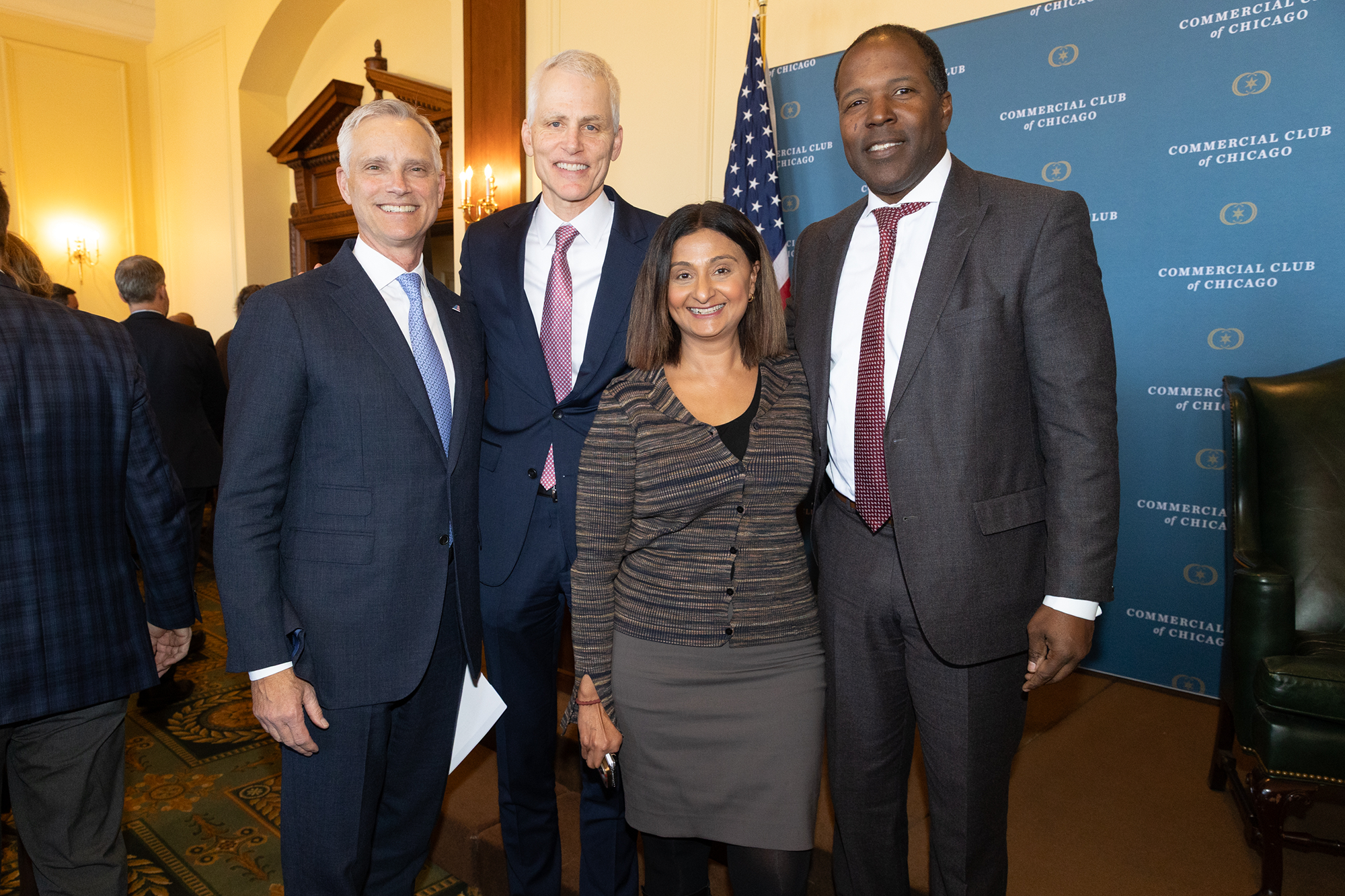Four people stand together
