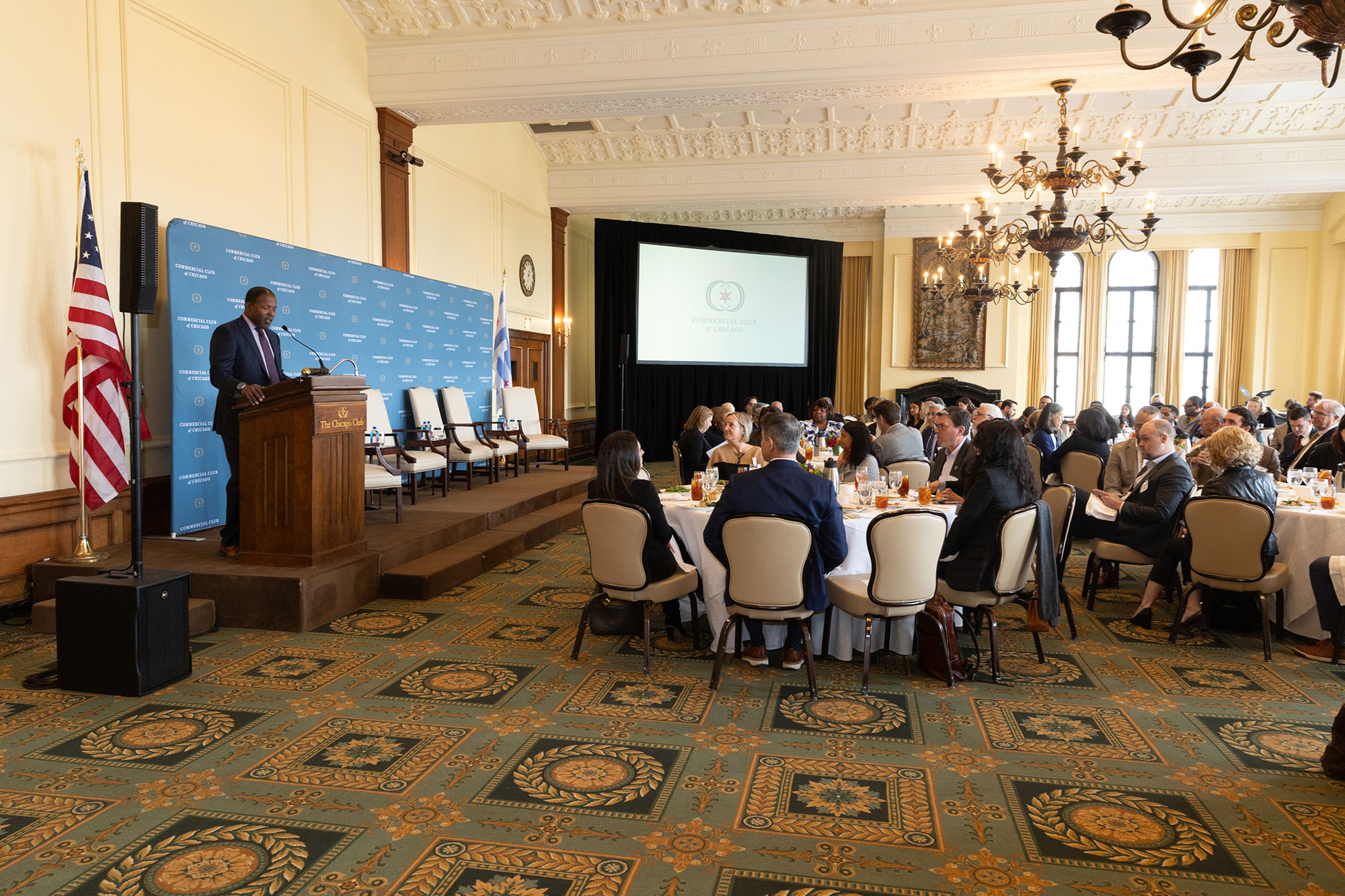 A room full of people sitting at tables