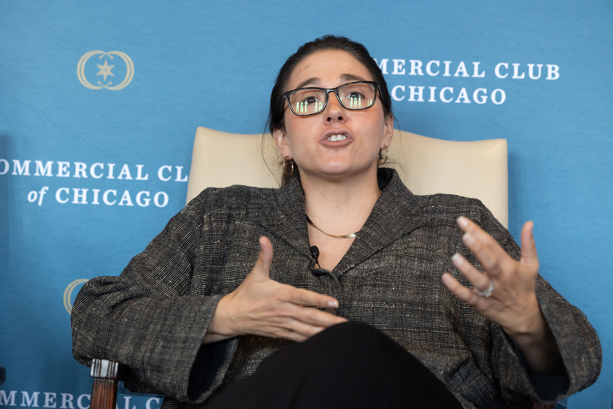 A person sitting in a chair and speaking