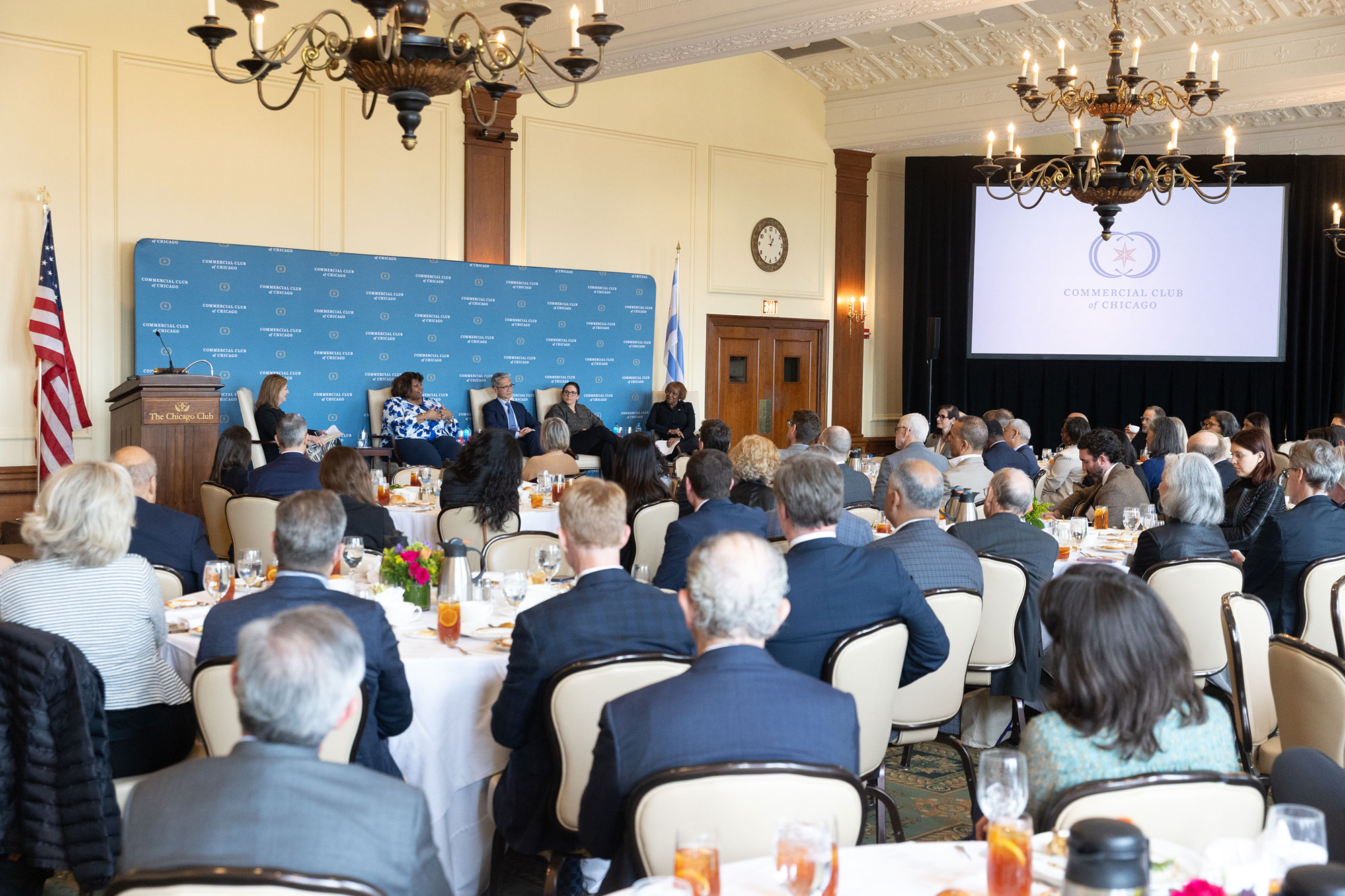 A room full of people sitting at tables
