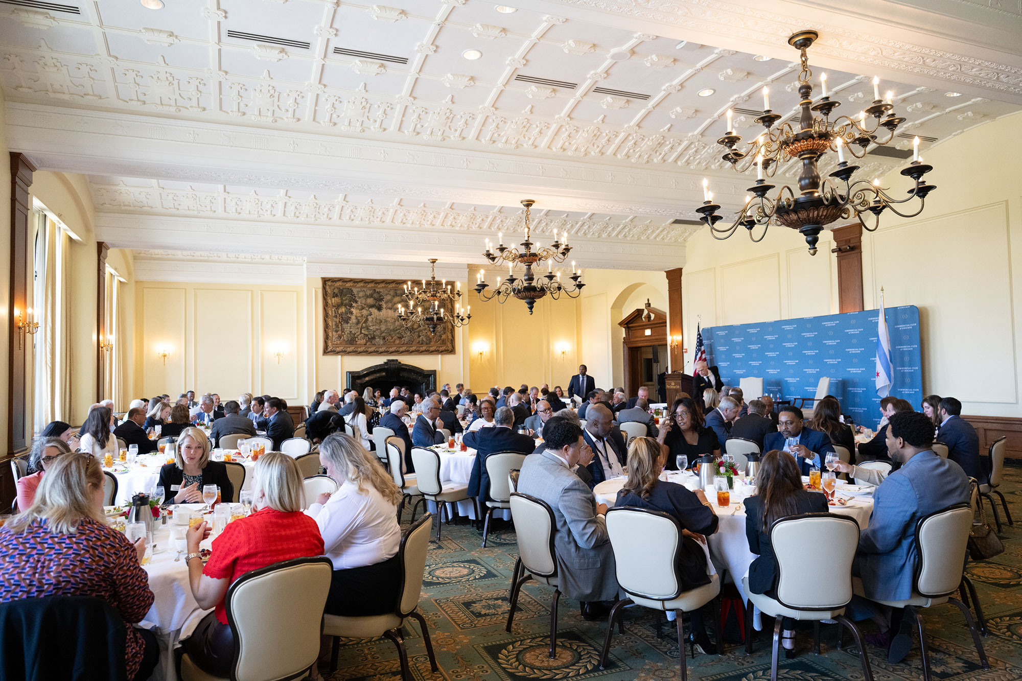 A room full of people sitting at tables