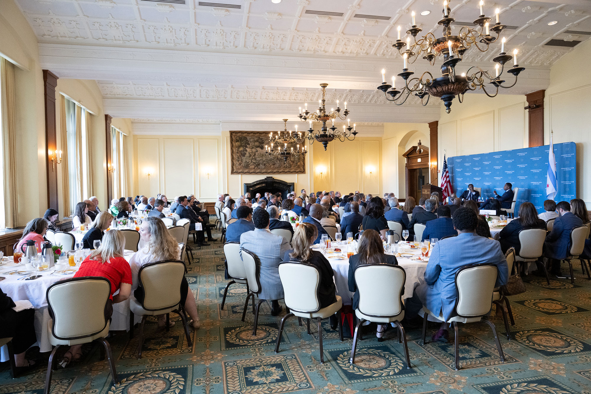 A ballroom full of people at tables