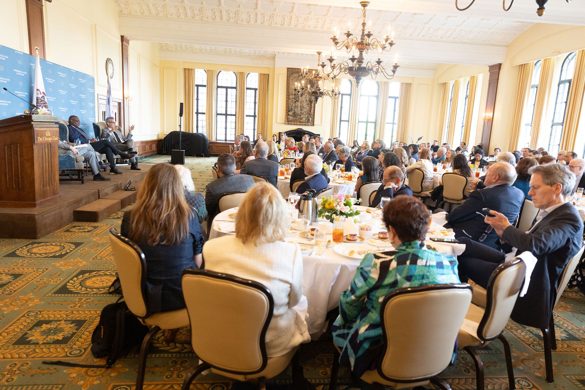 A room full of people sitting at tables