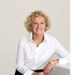 A professional headshot of a woman.